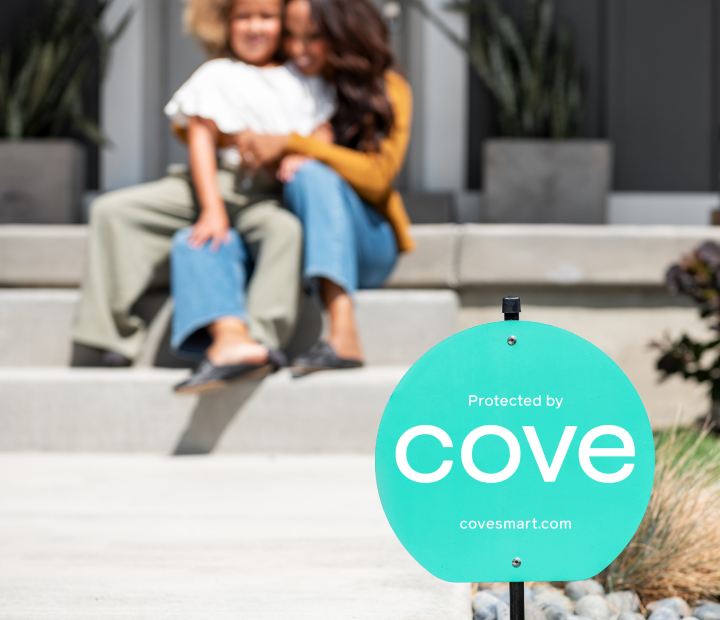 Cove yard sign with family in background