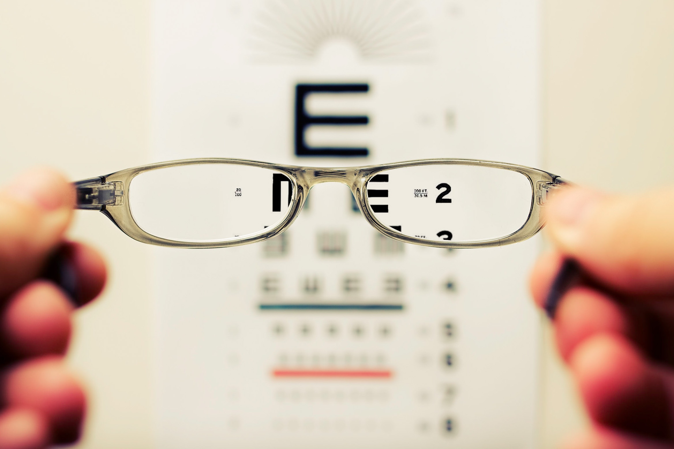 Glasses held up to view the poster at an eye exam.