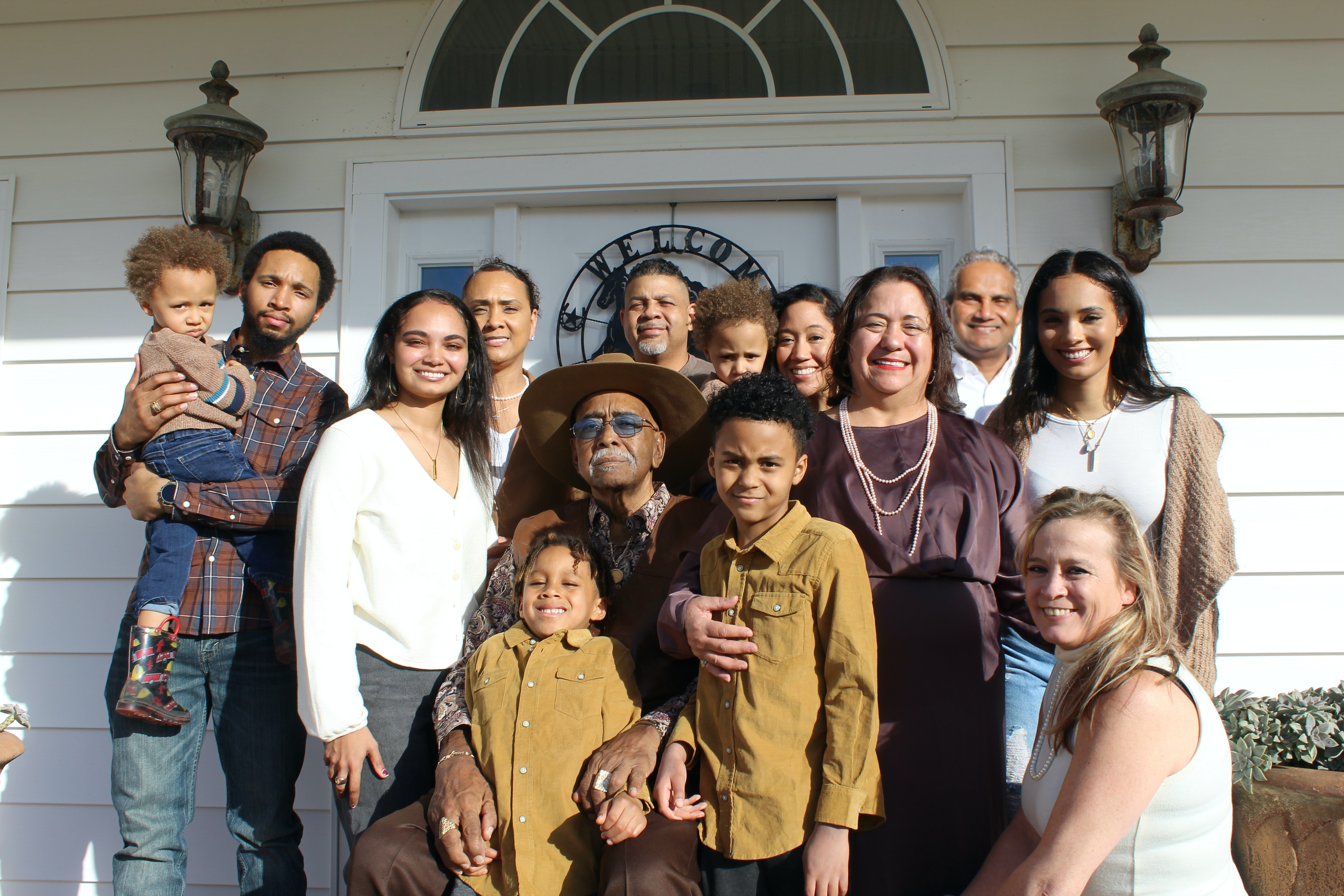 Generations of family on the front porch of a house.