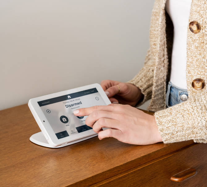 Woman using Coves security panel