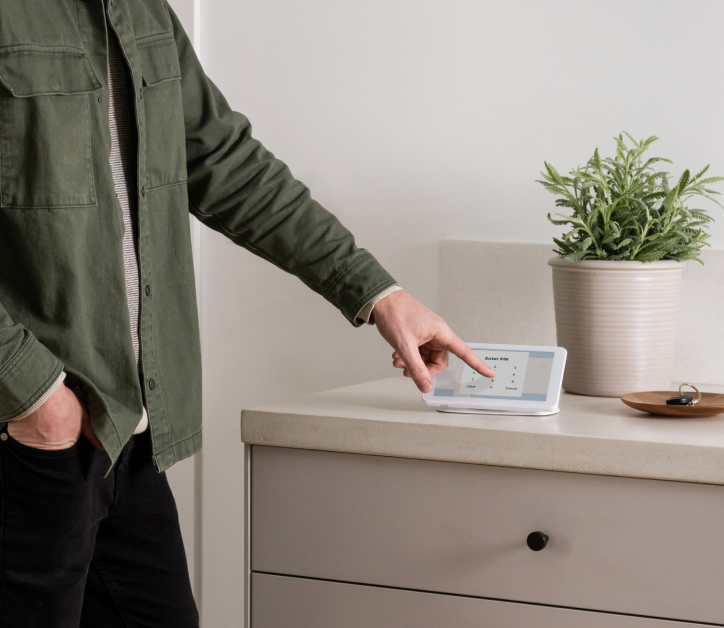 Man entering pin on Coves security panel