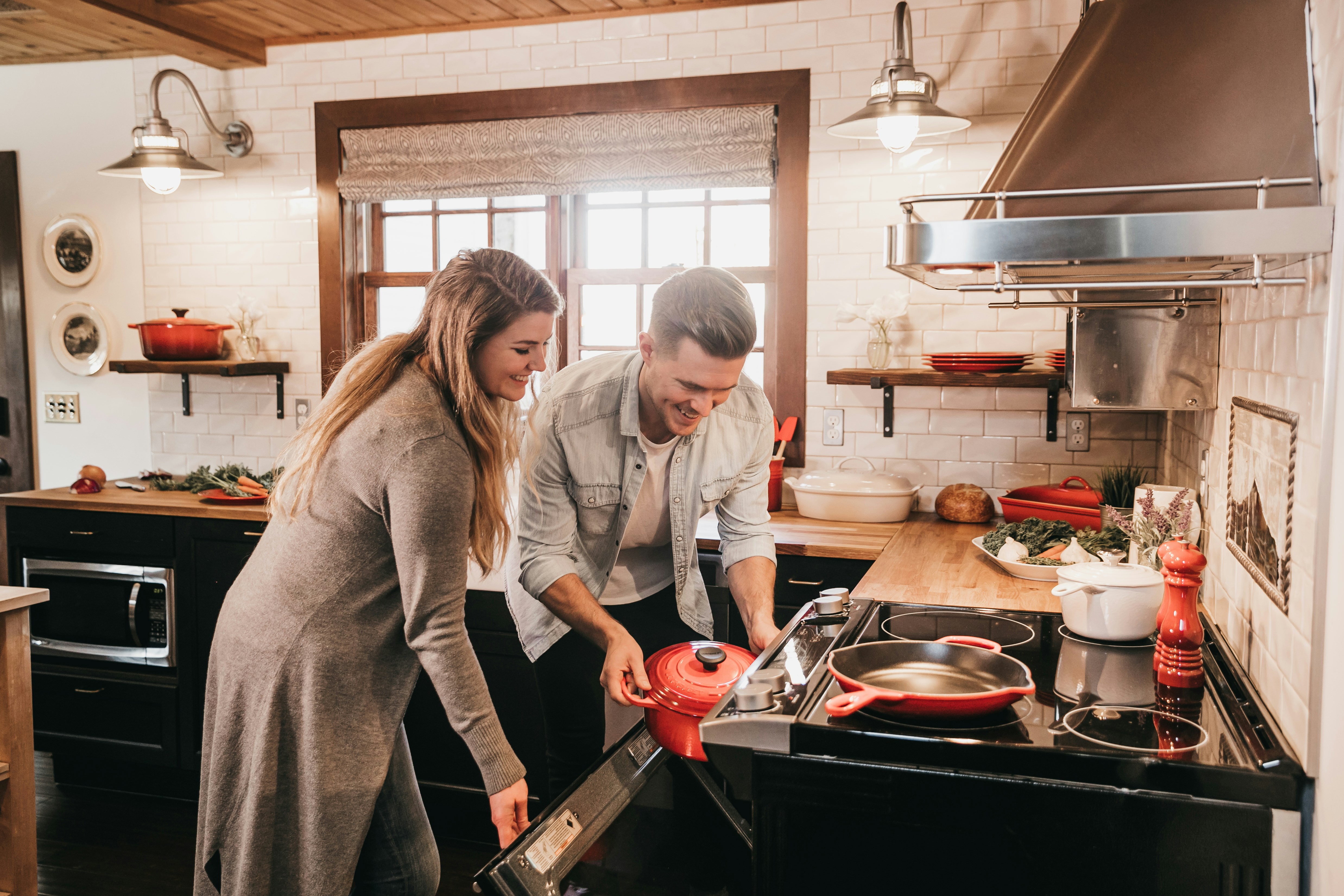 A couple doing holiday cooking in their kitchen.