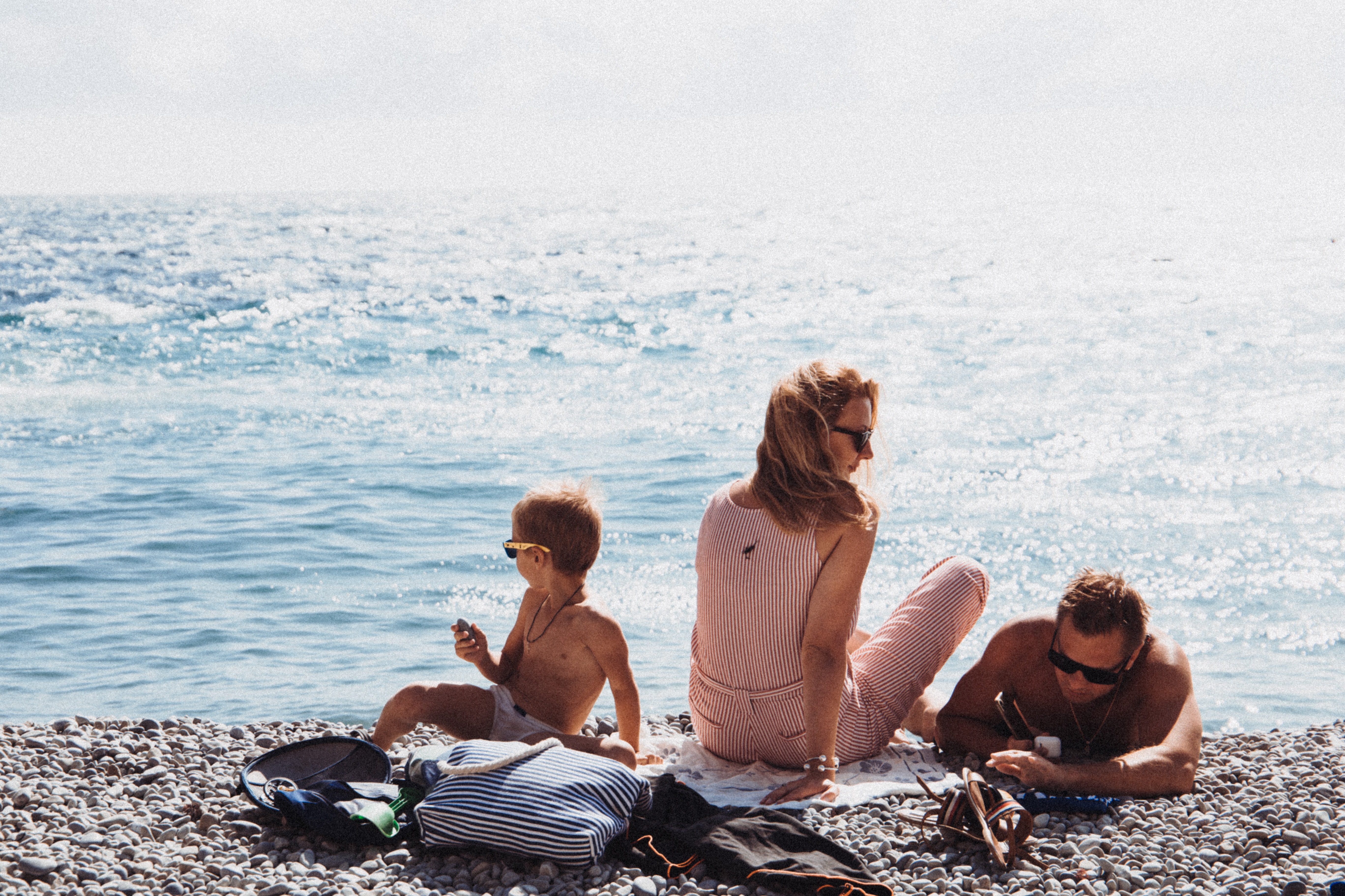 Family sitting on a beach while on vacation.