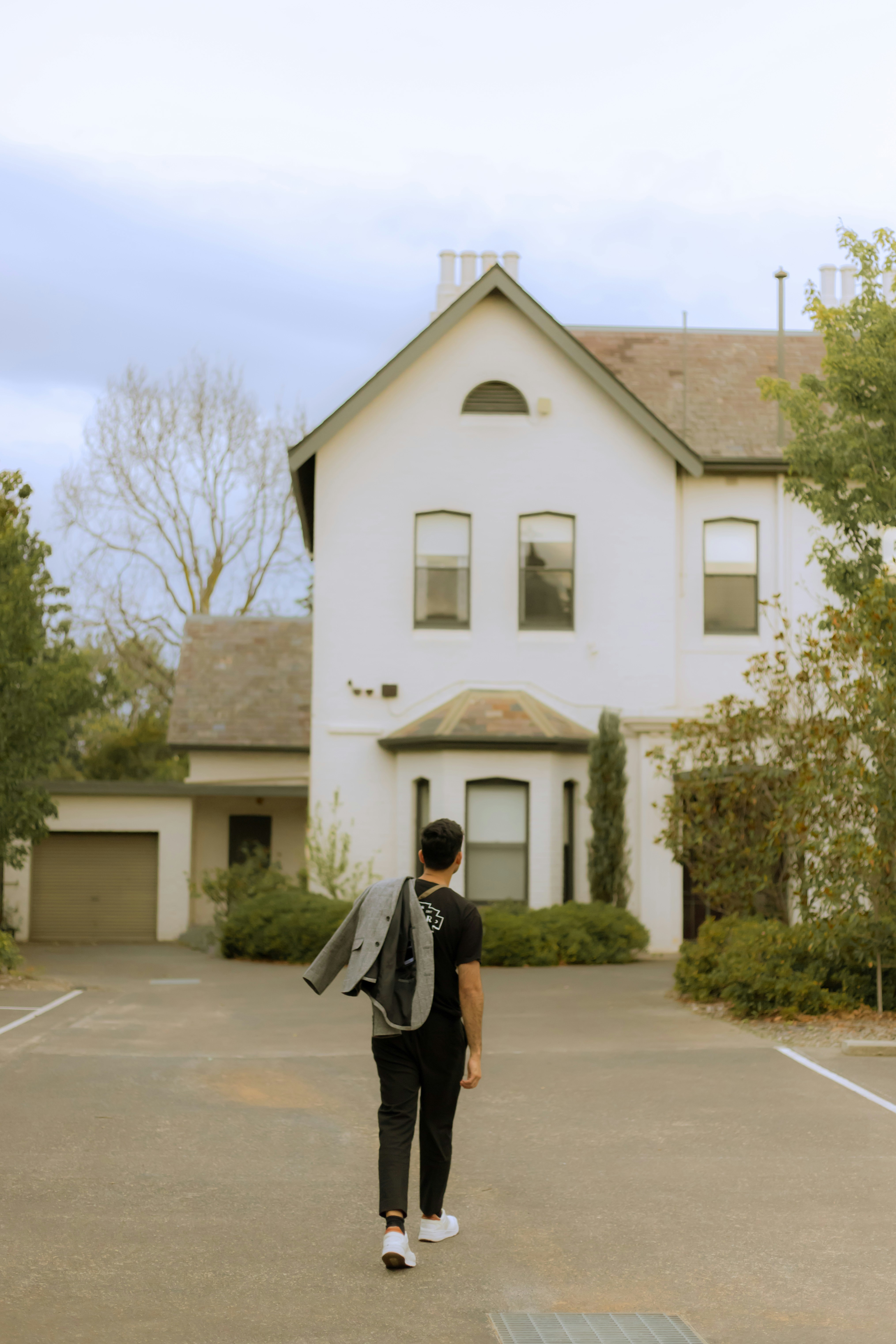 Young man walking towards his house.