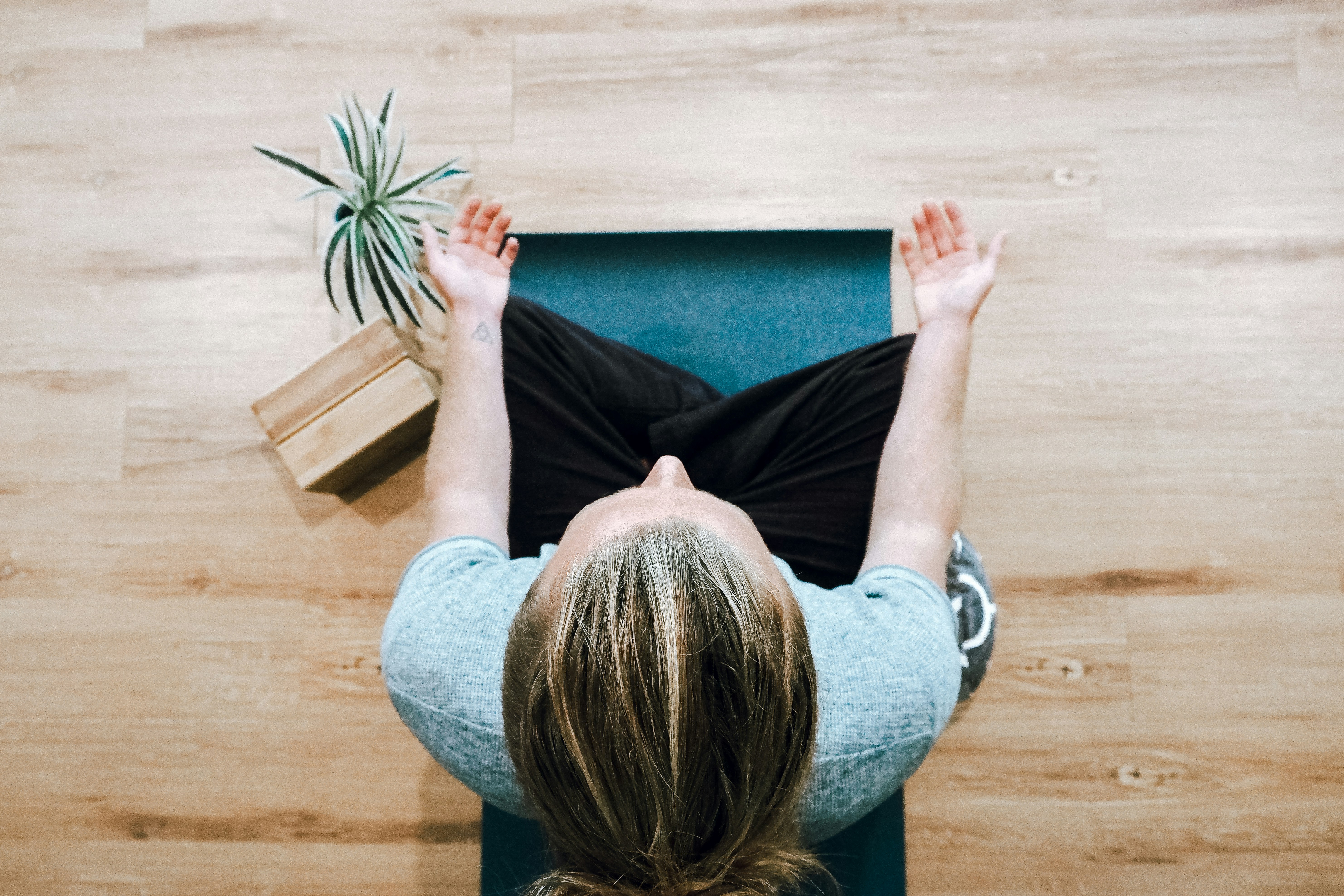 Woman sitting and practicing meditation so she can sleep better.