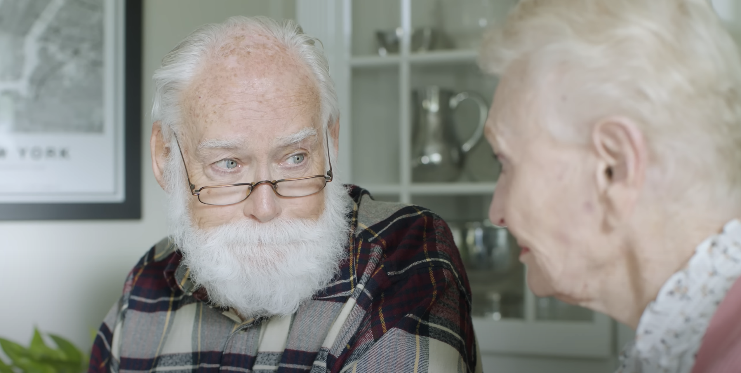 Elderly man looking at his wife.