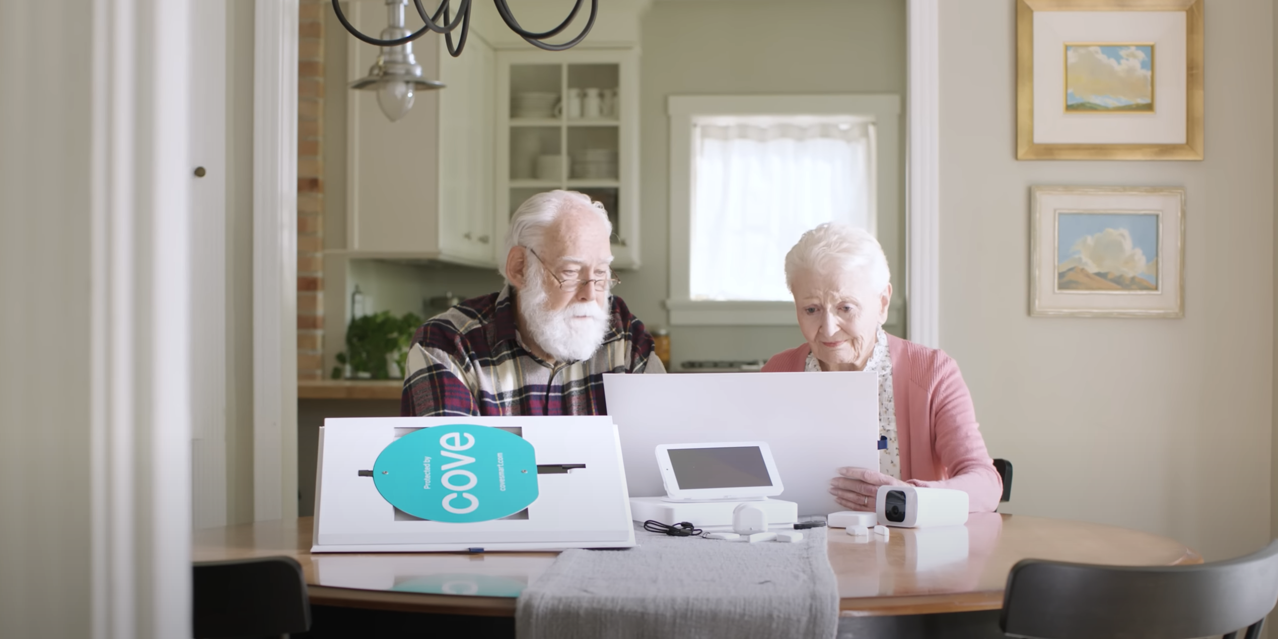 Elderly couple installing the Cove home security system.