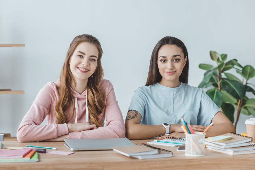 Two college students studying together and they are also roommates.