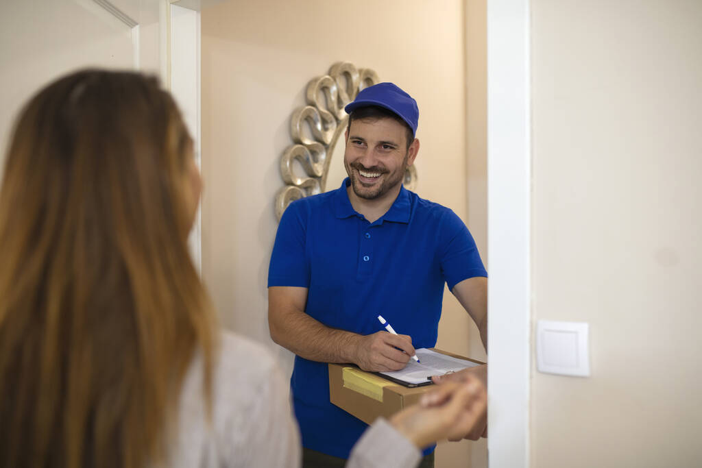 Delivery man with a box at a woman's front door.