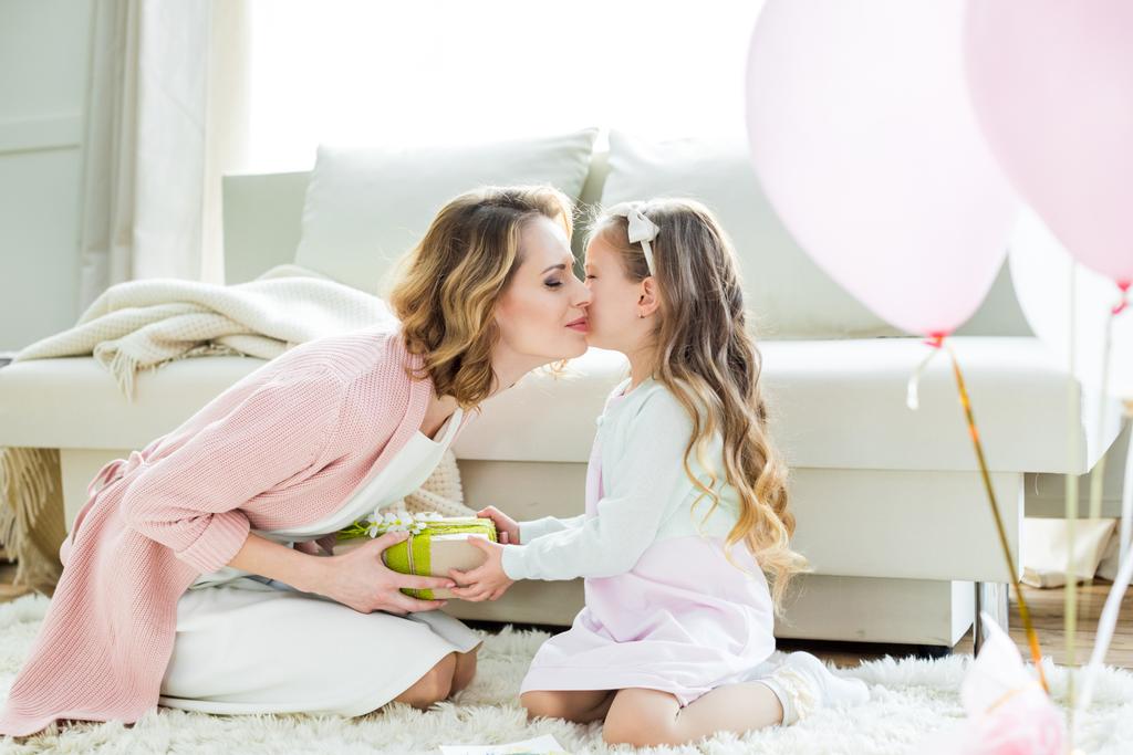 Daughter giving mom a Mother's Day gift