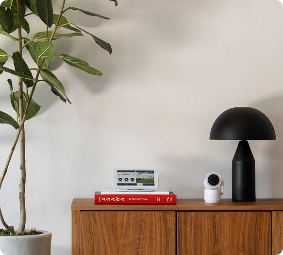 Cove Indoor Cam on desk with alarm panel