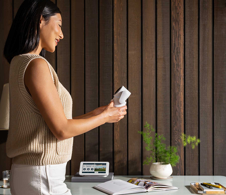Woman setting up Cove Indoor Cam