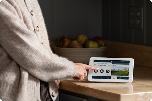 Person using the Cove mobile app to arm the security system