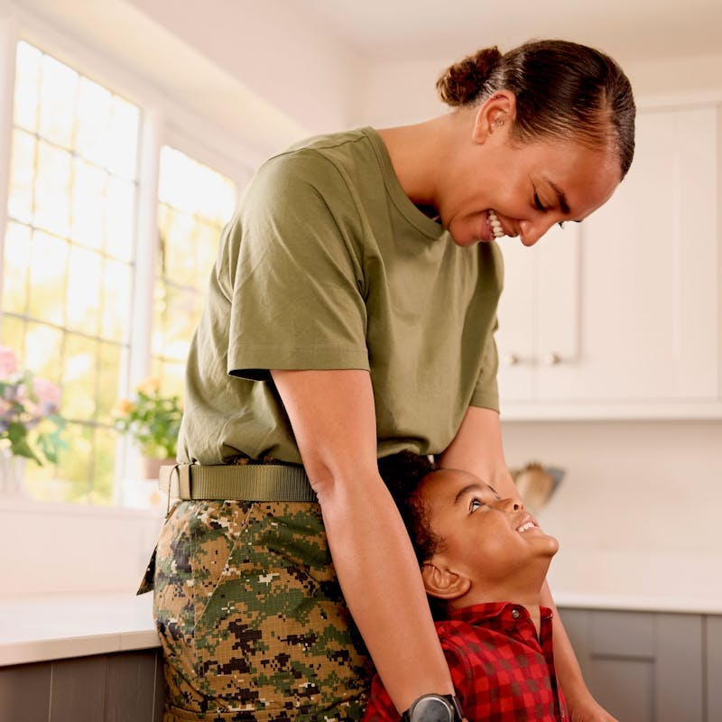 Military mom embracing her child