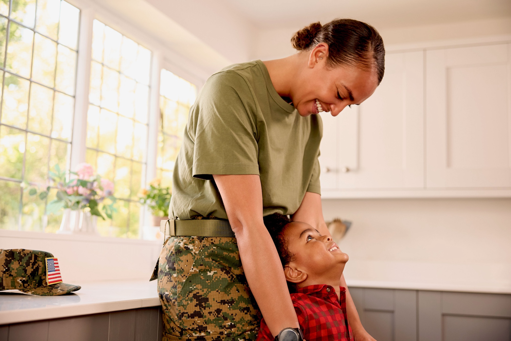 Military mom embracing her child
