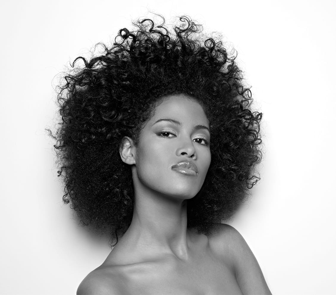 black and white photo of woman with afro hair