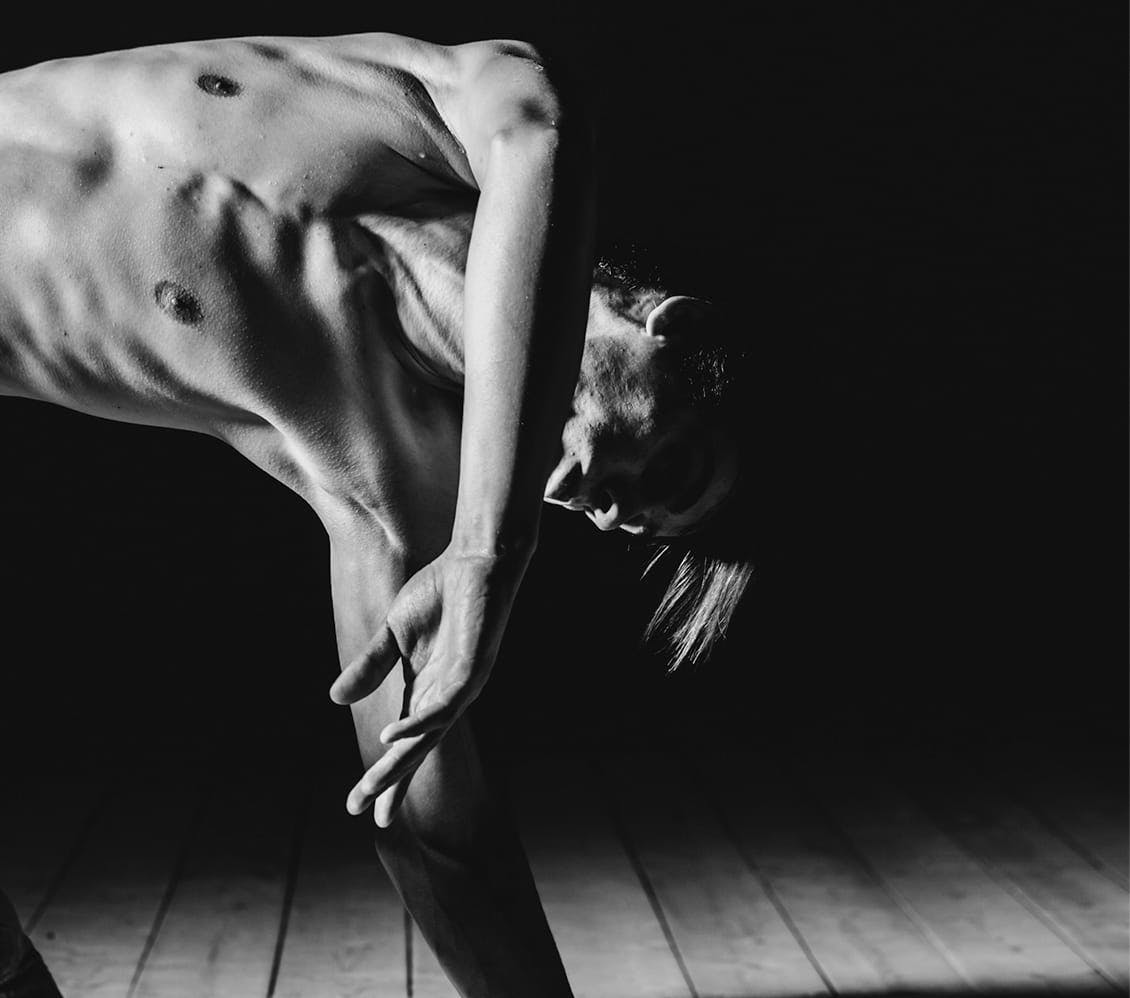 black and white photo of a man stretching