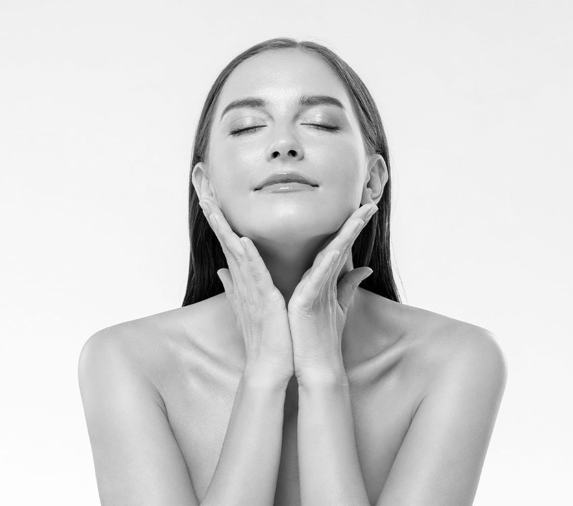 black and white photo of a woman cupping her face