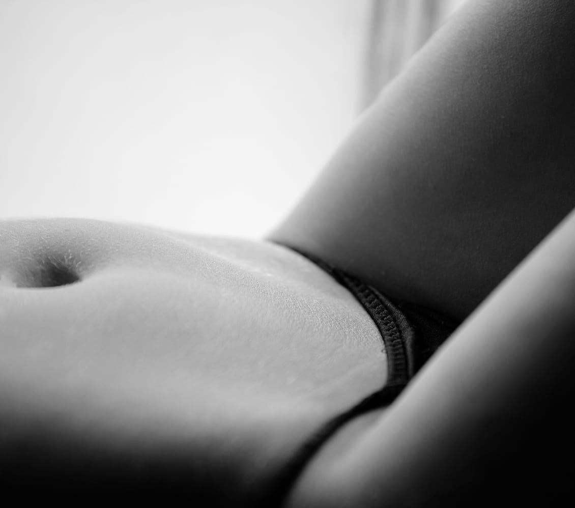 black and white photo of a woman's lower stomach