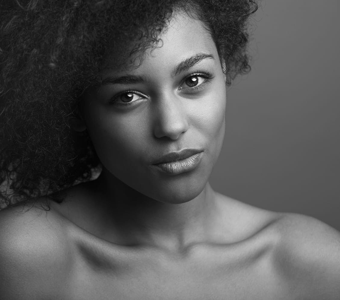black and white photo of a woman with afro hair
