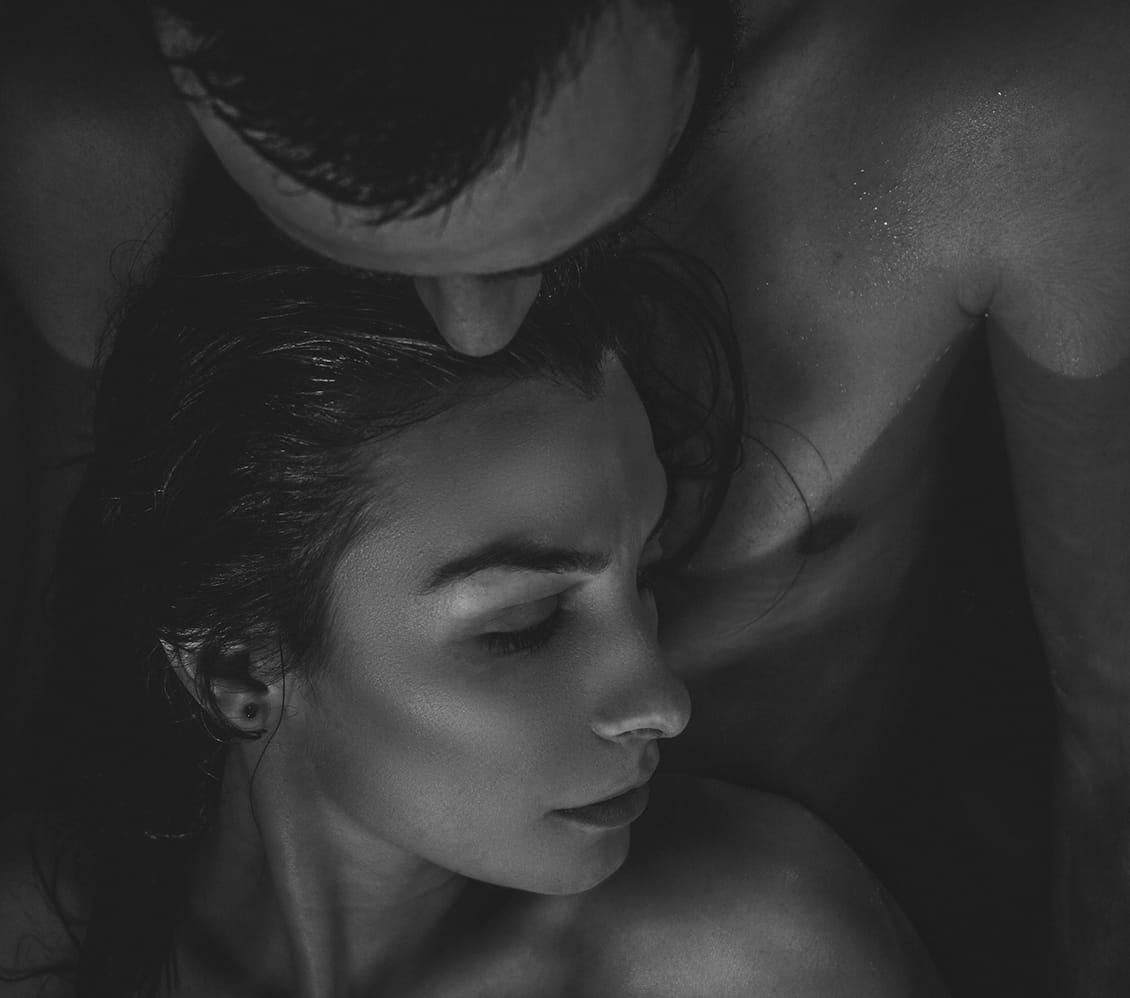 black and white image of a man holding a woman