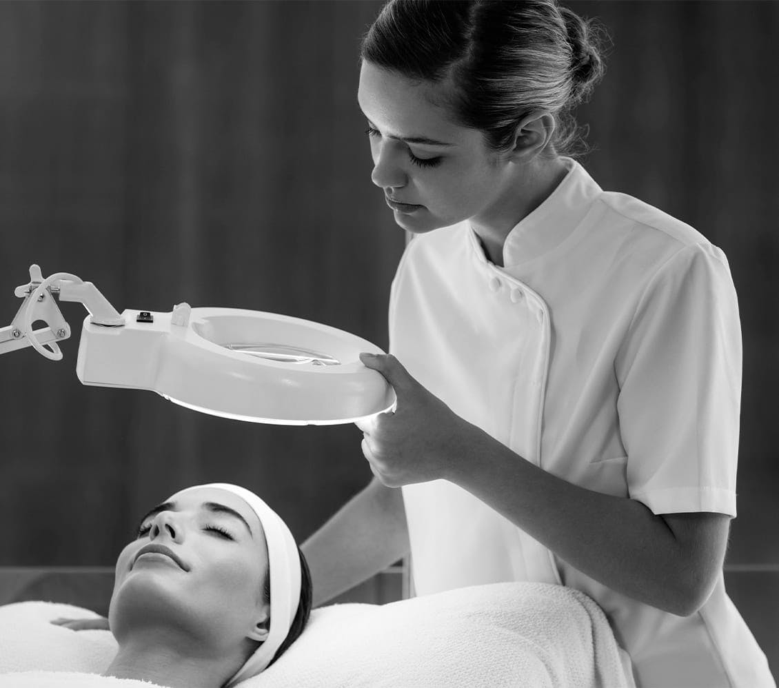 black and white photo of a nurse looking at patient