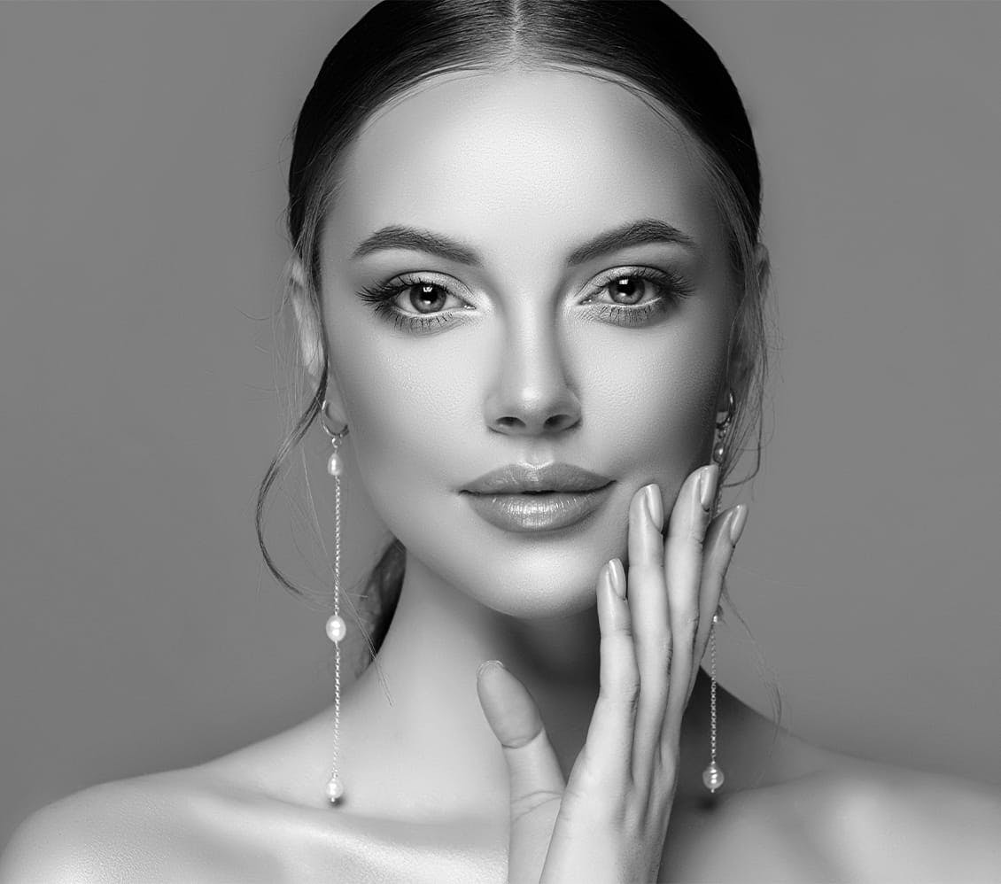 black and white photo of a woman touching her face