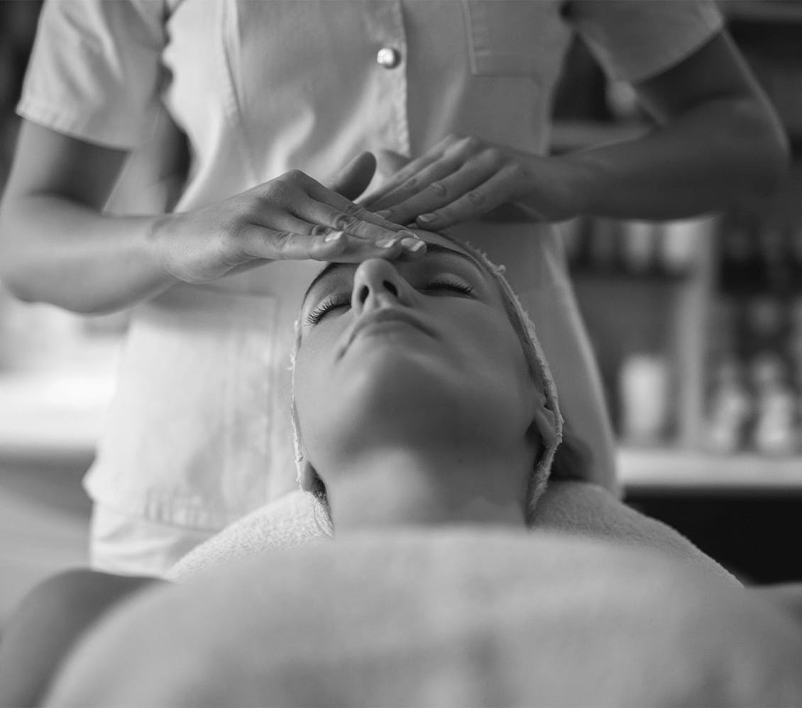 black and white image of a woman getting a facial