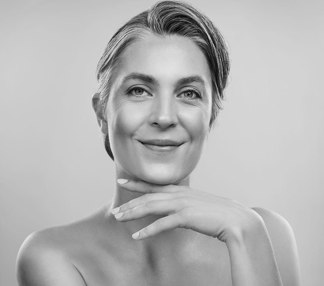 black and white photo of a woman touching her chin