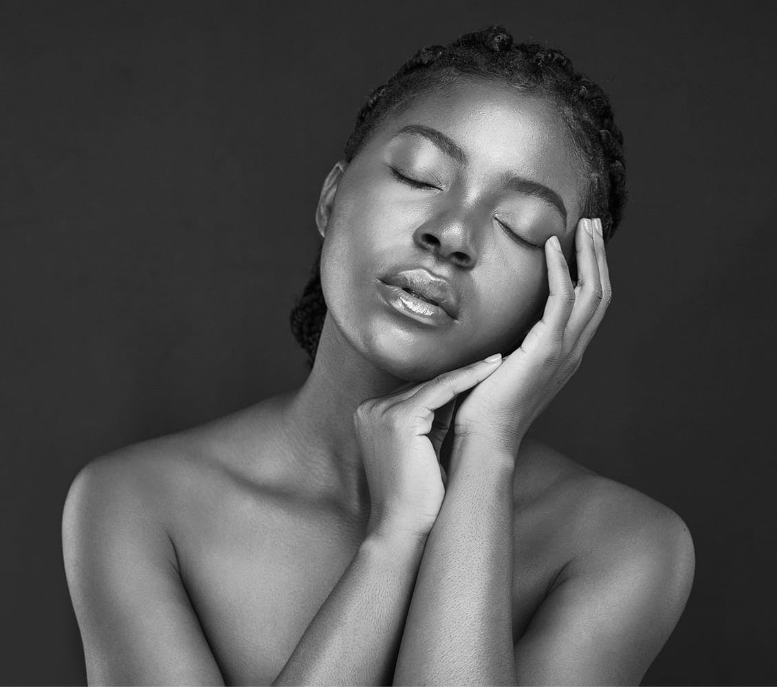 black and white photo of a woman holding her chin