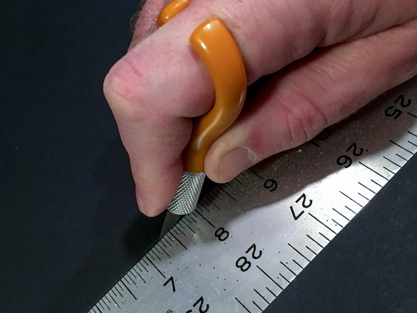 A long, metal ruler is great for this sort of cutting. 