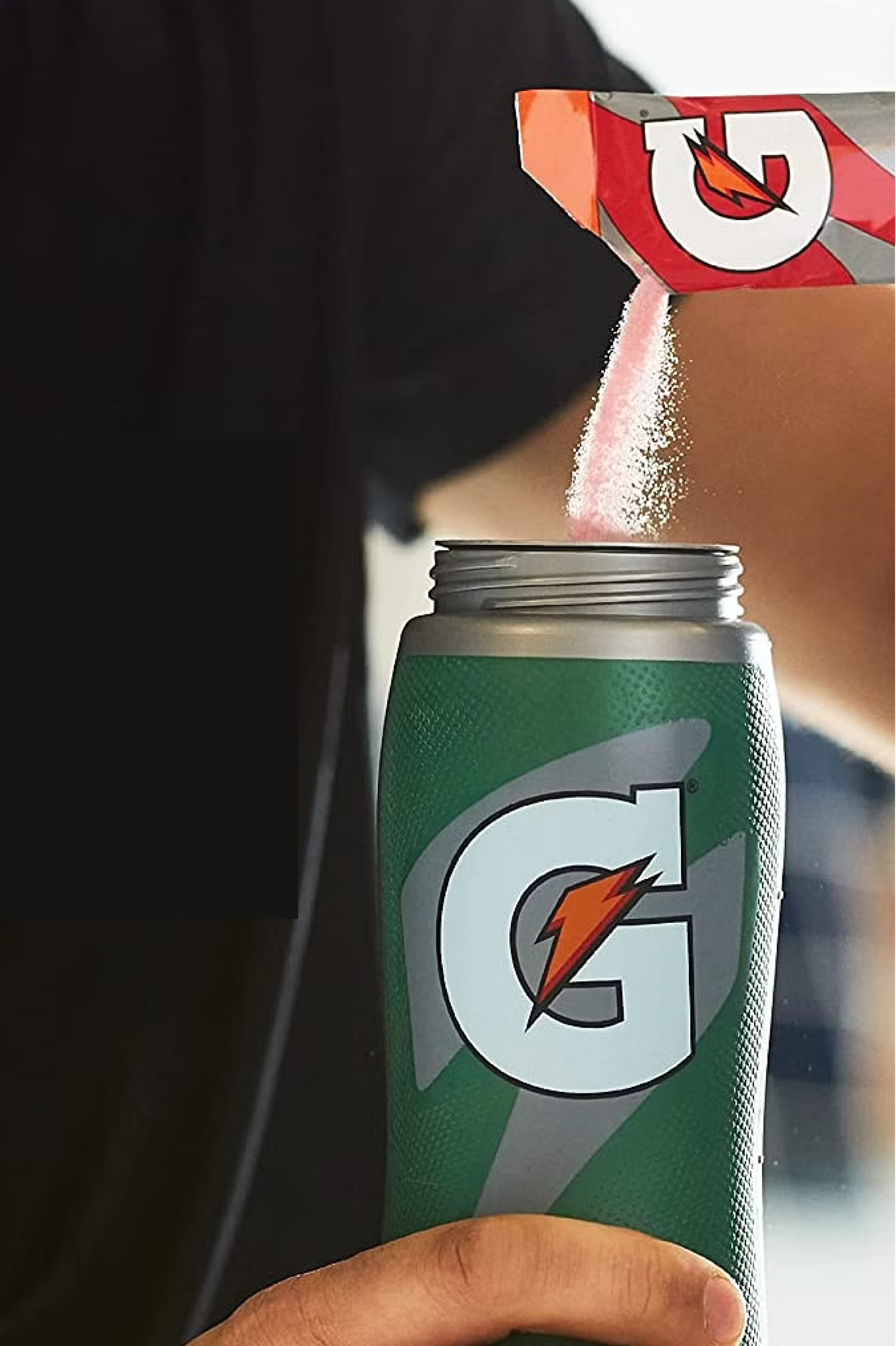 Gatorade thirst quencher fruit punch being poured into Gx bottle