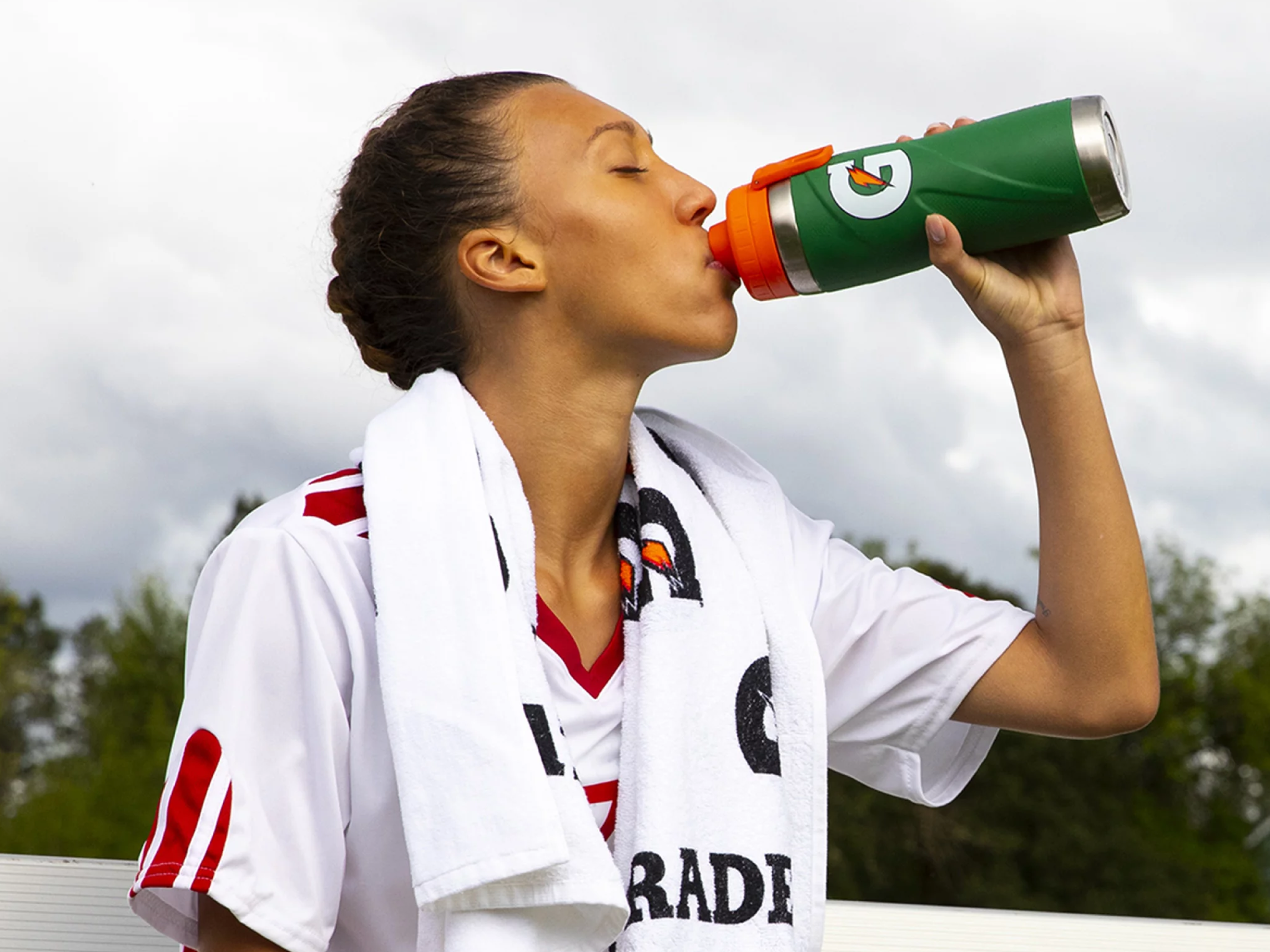Athlete drinking from Gx bottle