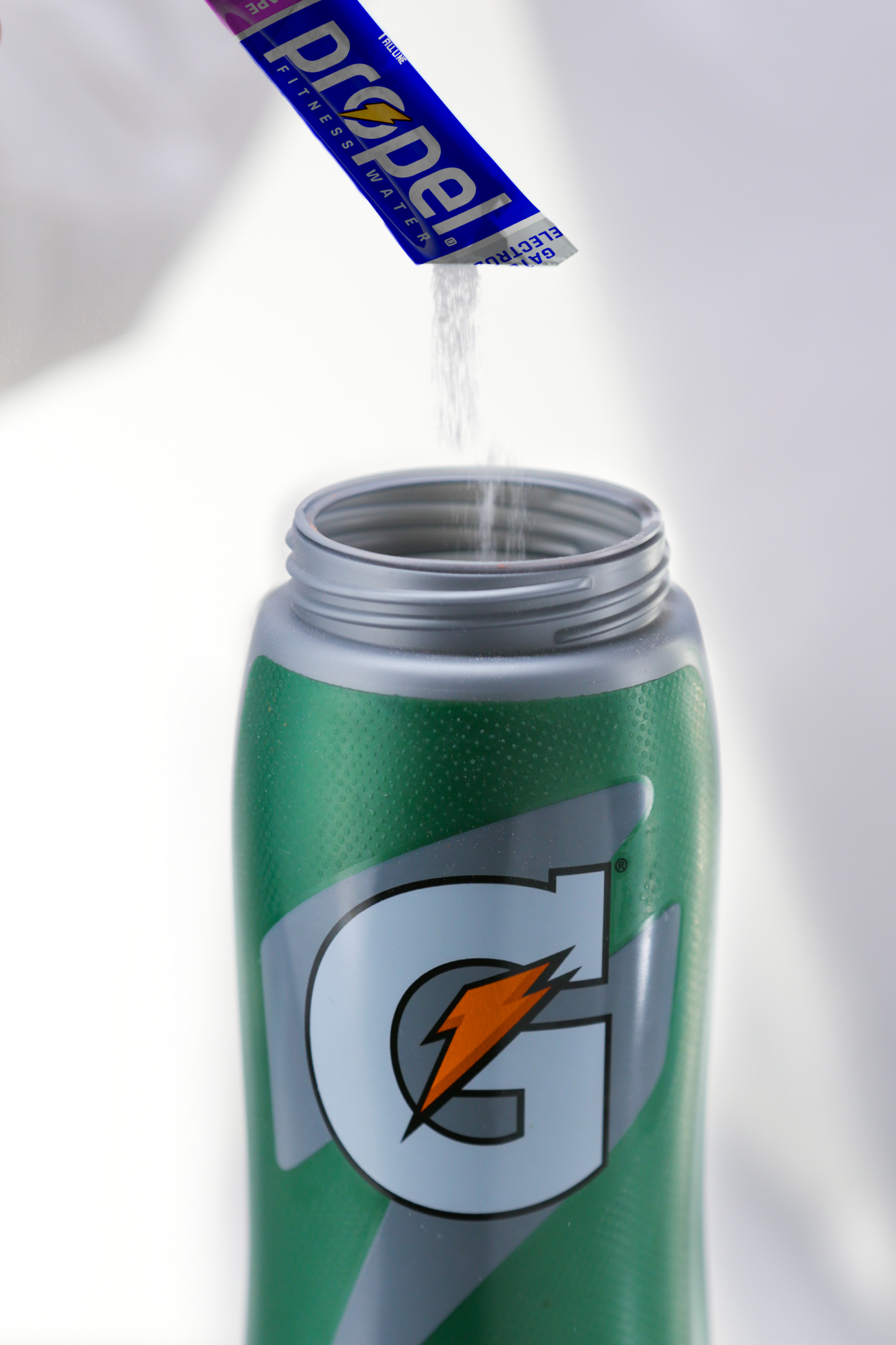 Propel single serve powder berry being poured in Gx bottle