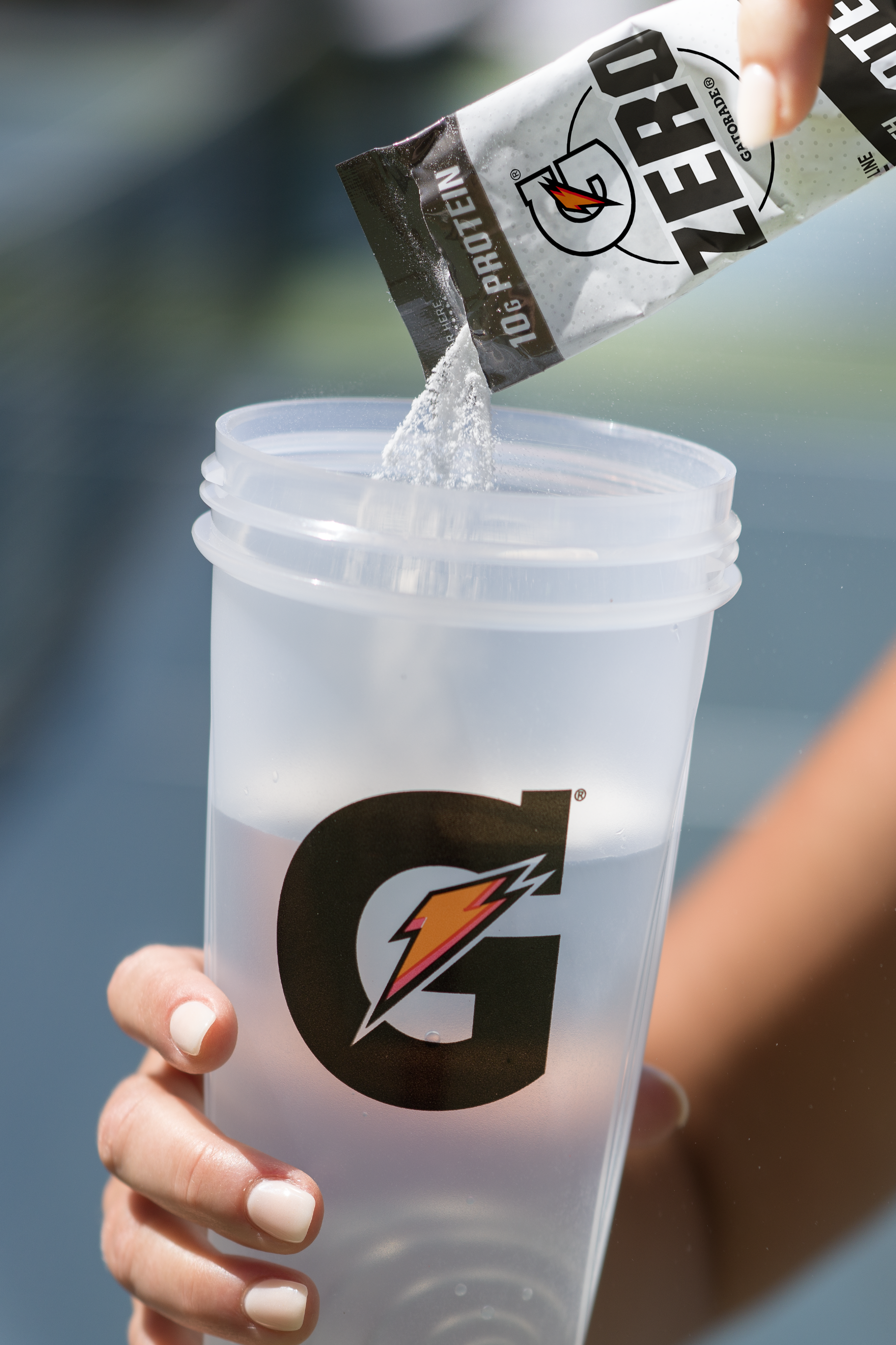 Gatorade Zero with Protein pouring into a Gx Shaker Bottle