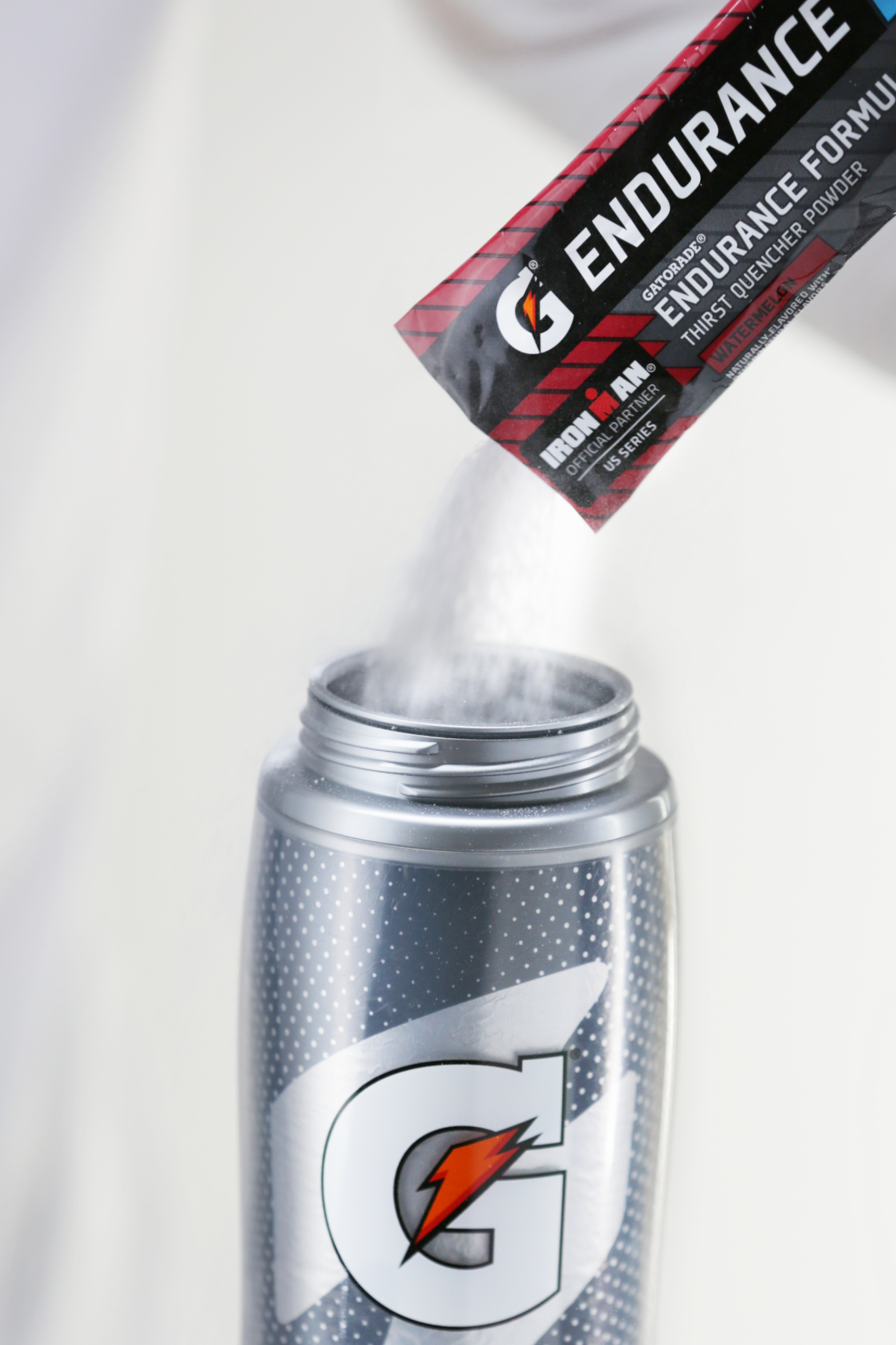 Cherry endurance single serve powder being poured into Gx bottle