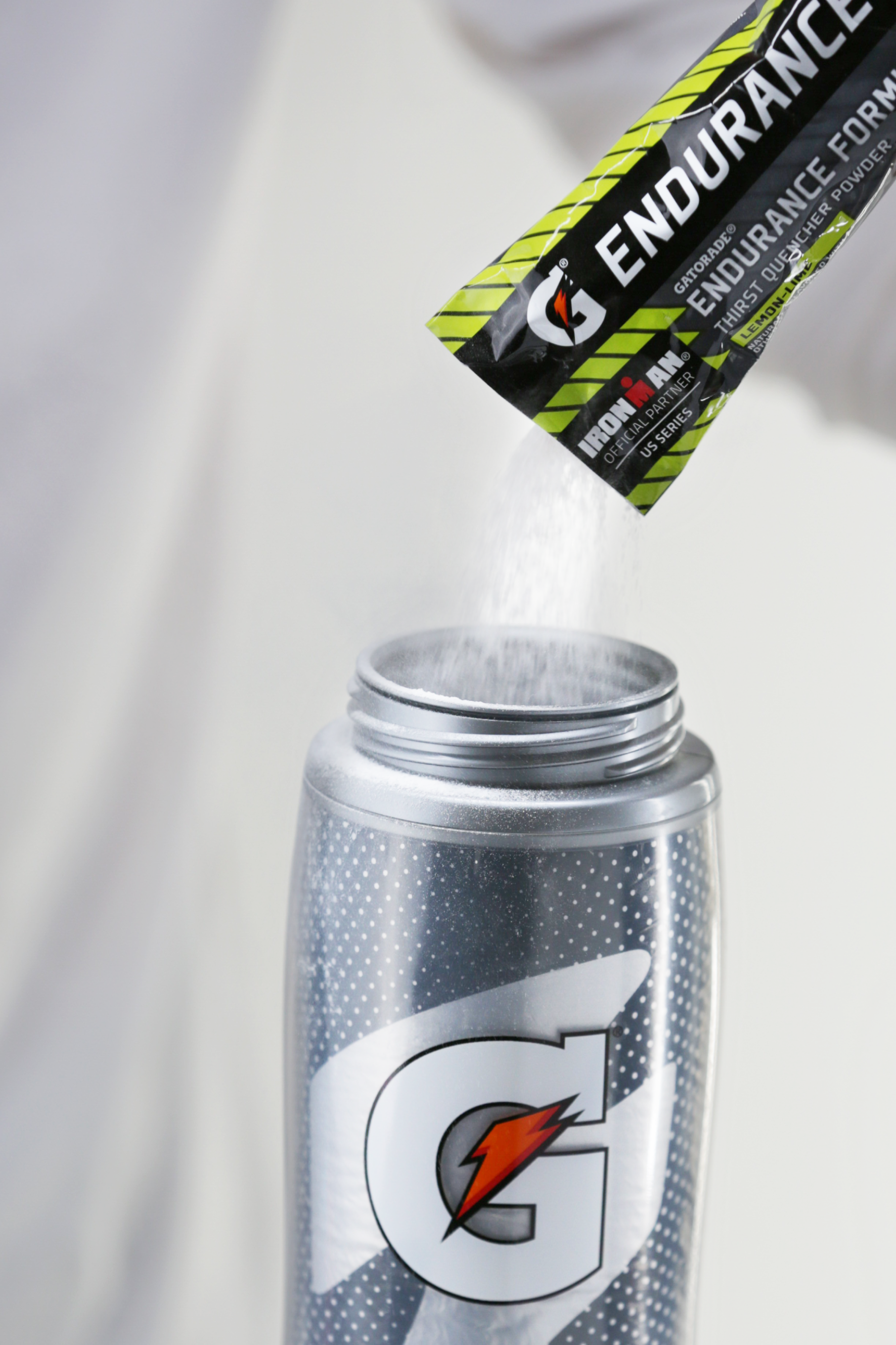 Lemon Lime endurance single serve powder being poured into Gx bottle