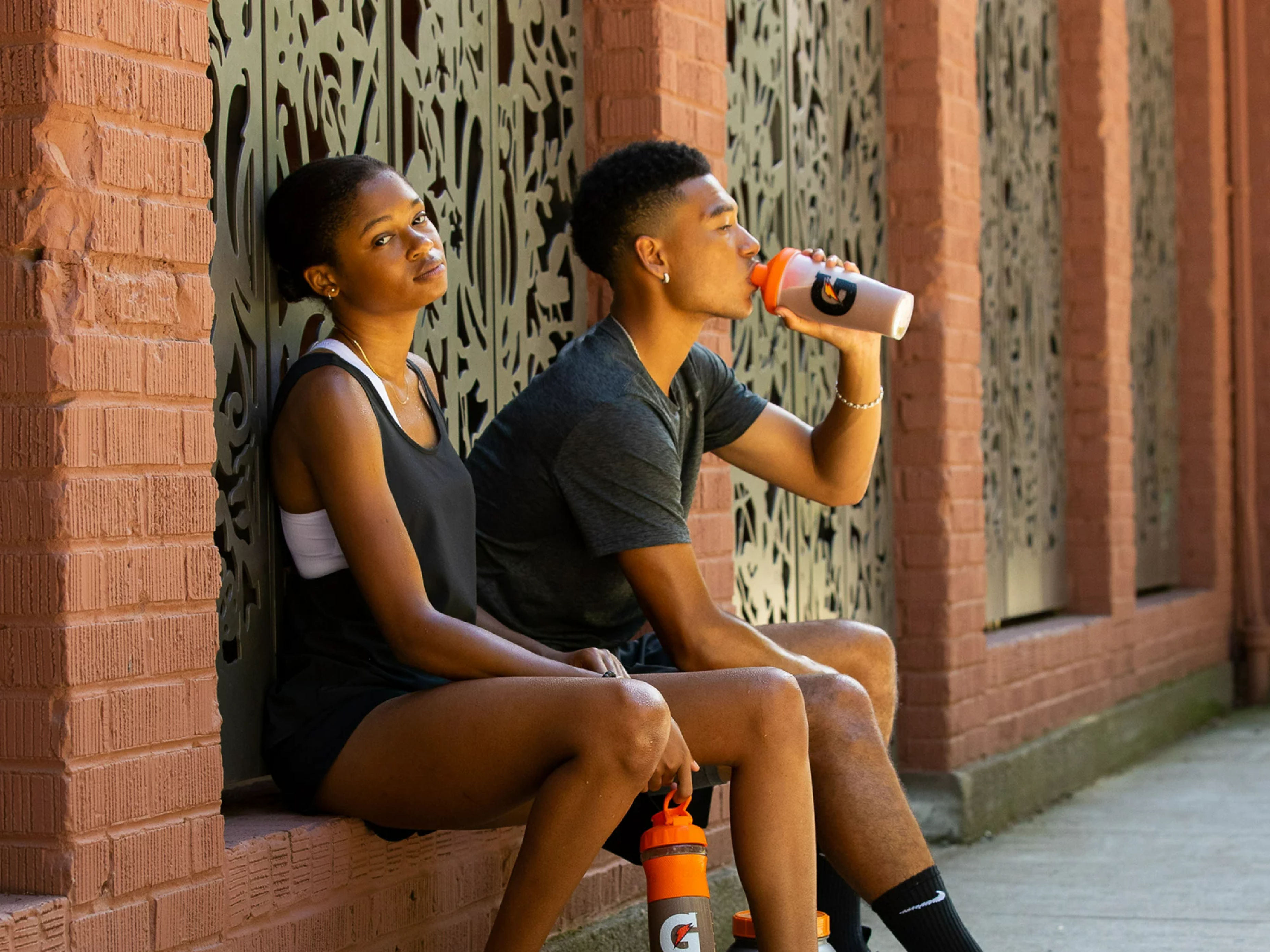 Athletes drinking out of Gatorade shaker bottles