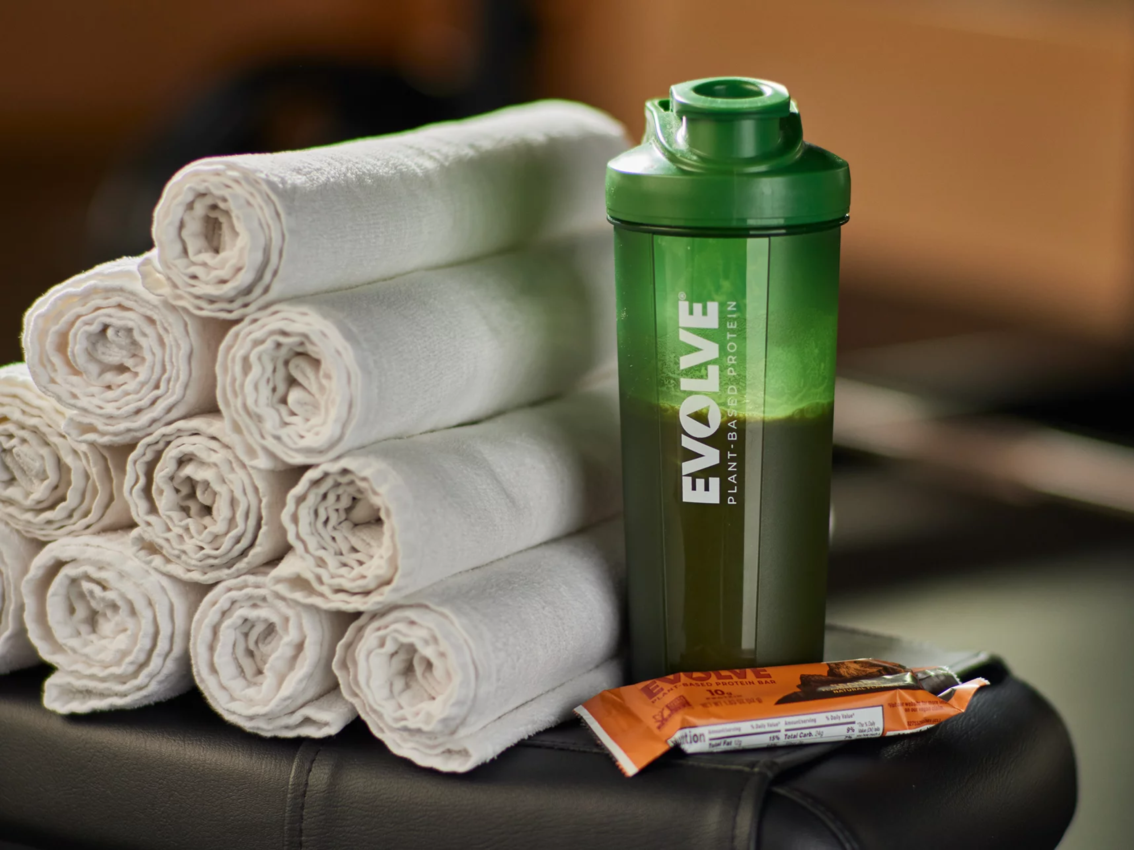 Towels, evolve shaker bottle and evolve protein bar