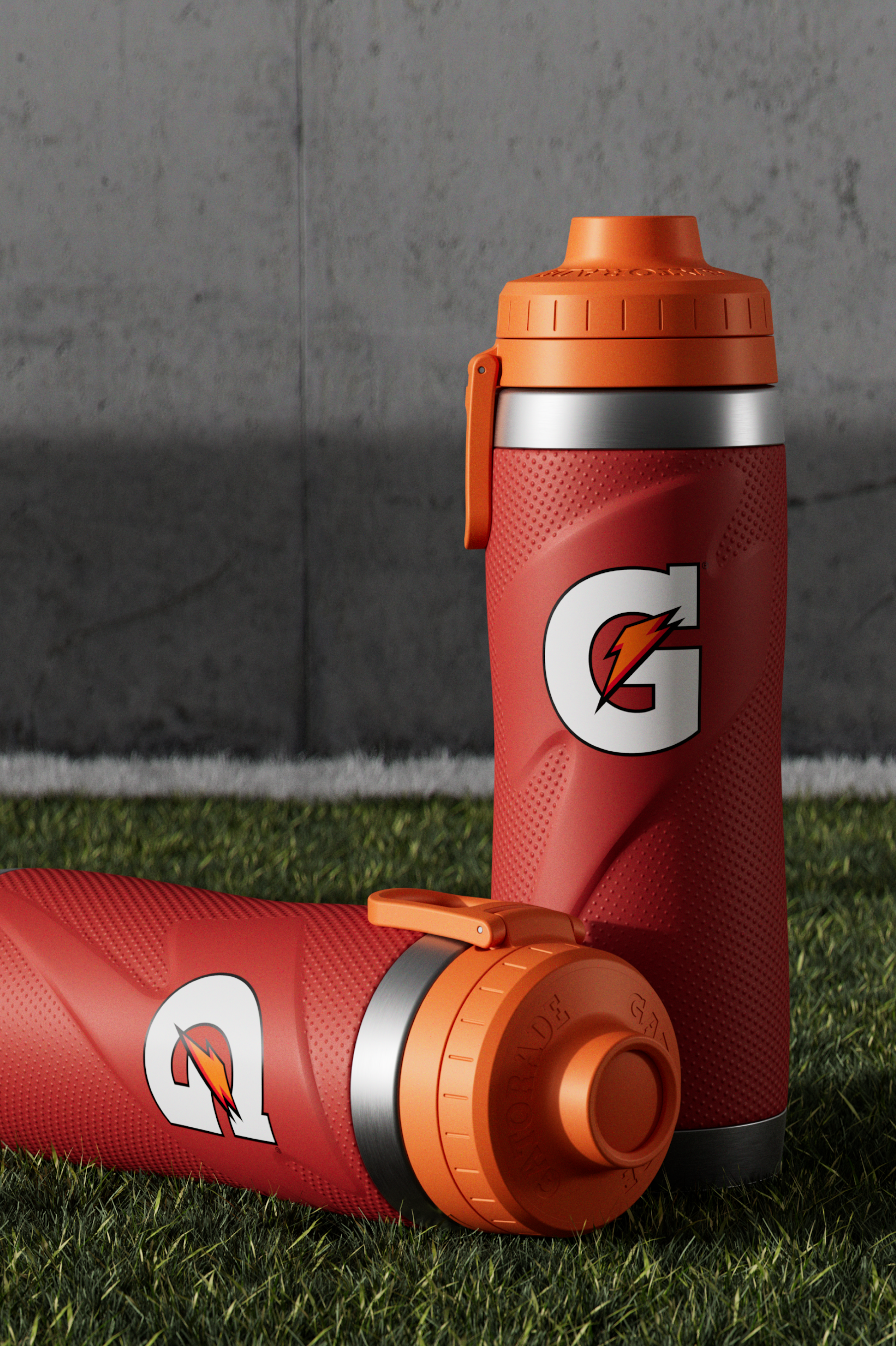 Red stainless steel bottles on turf
