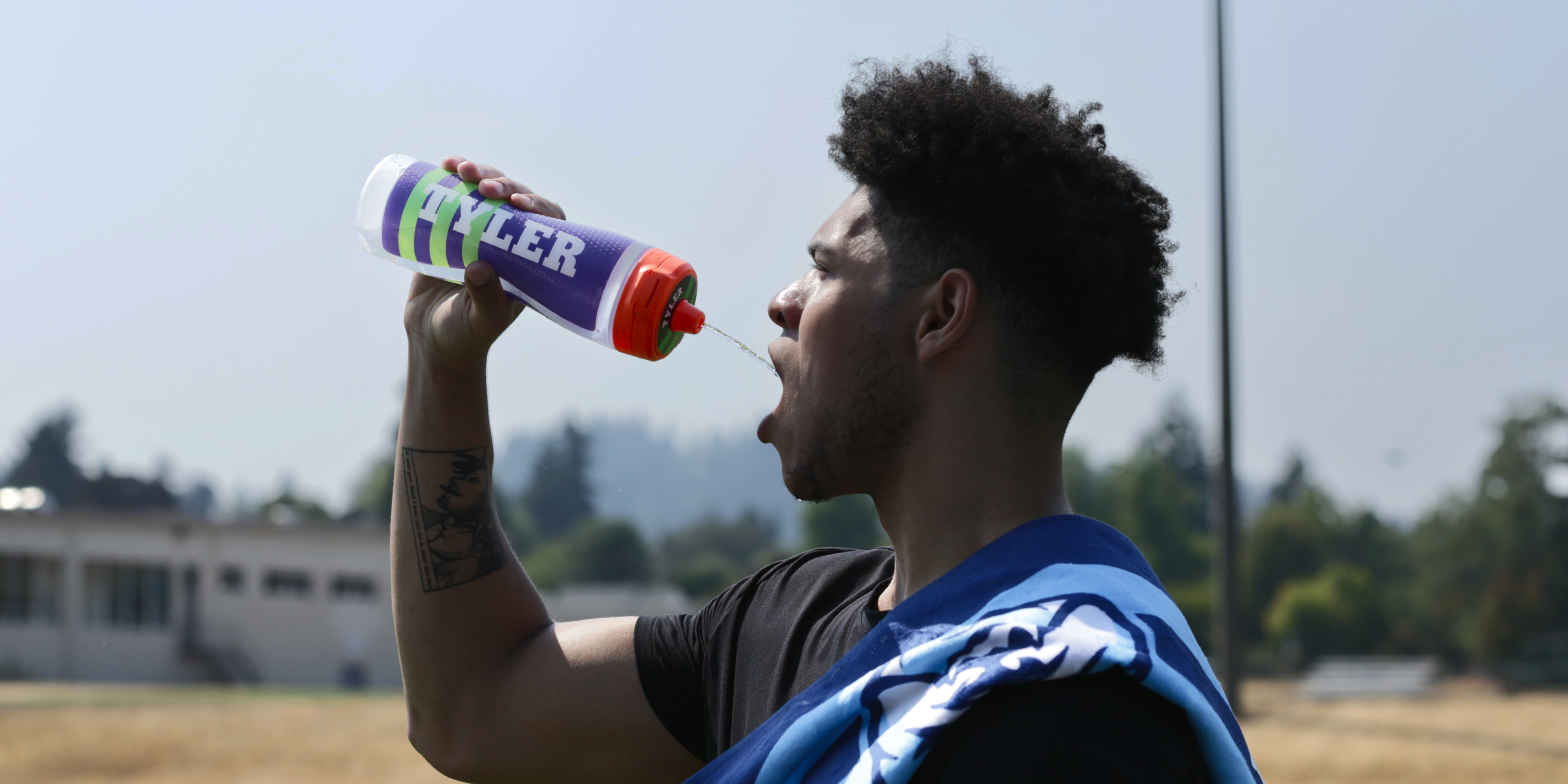 Athlete drinking out of Gx bottle