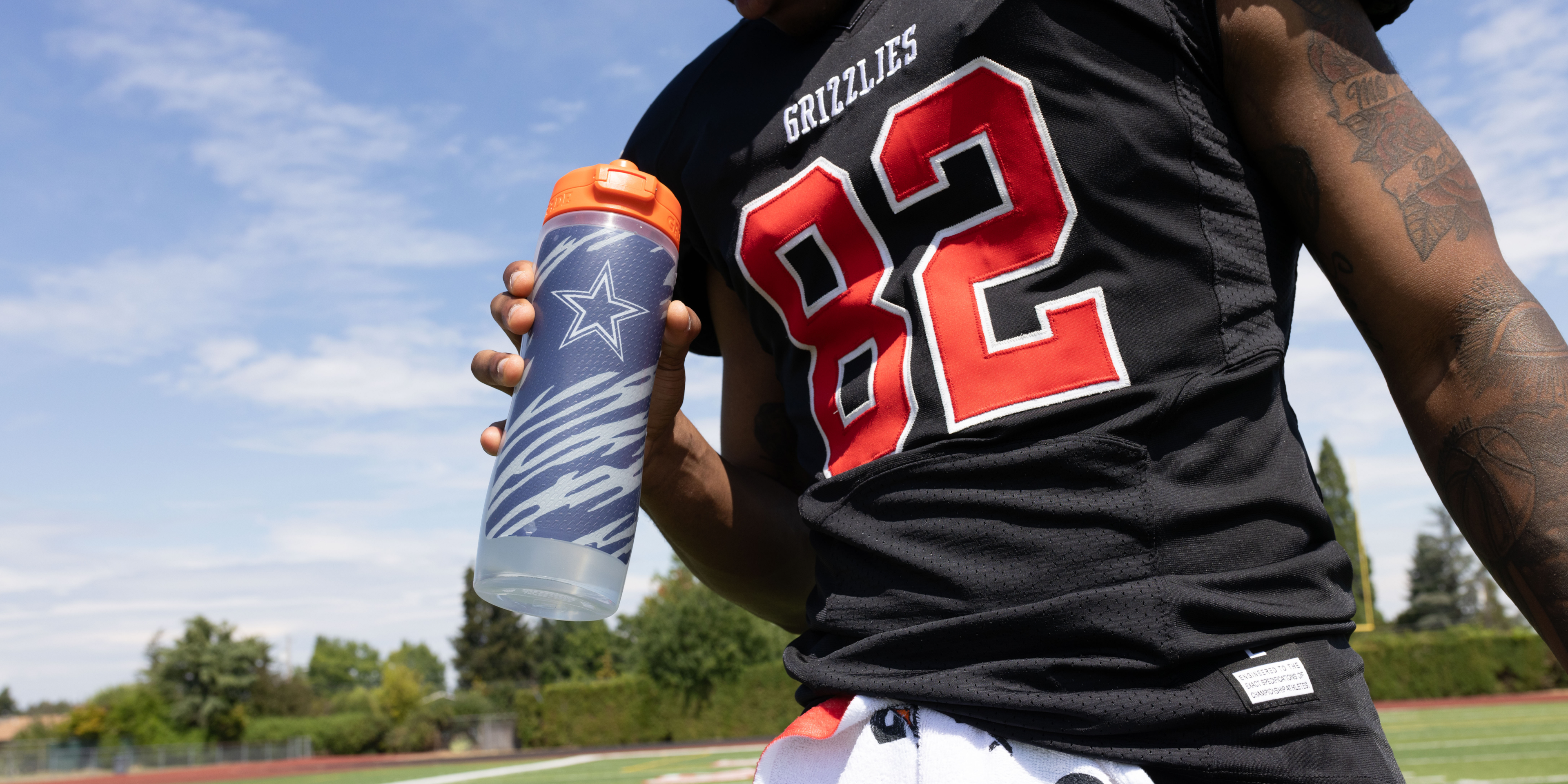 NFL athlete holding Gx NFL bottle
