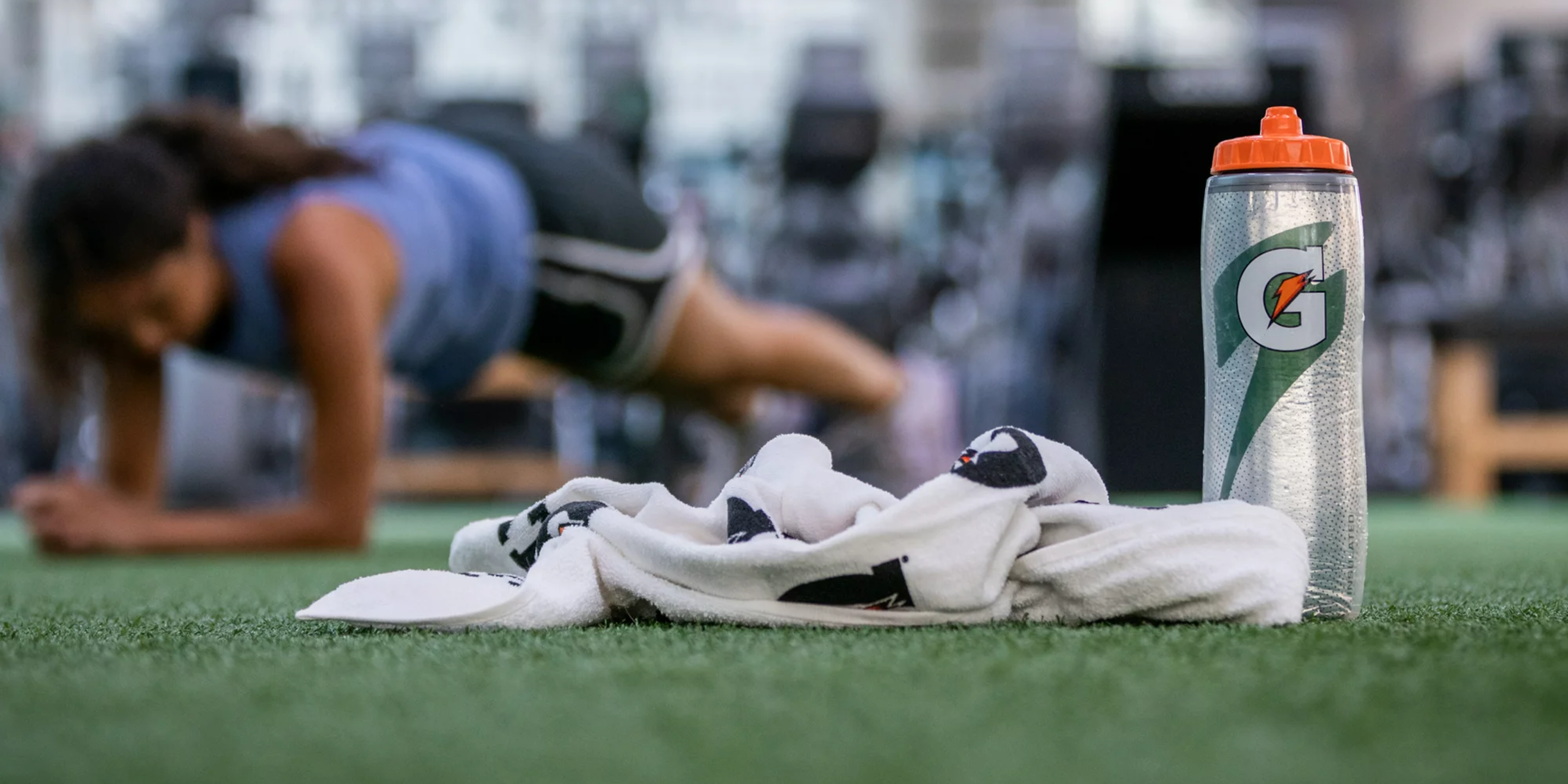 Gx towel and Insulated squeeze bottle on turf