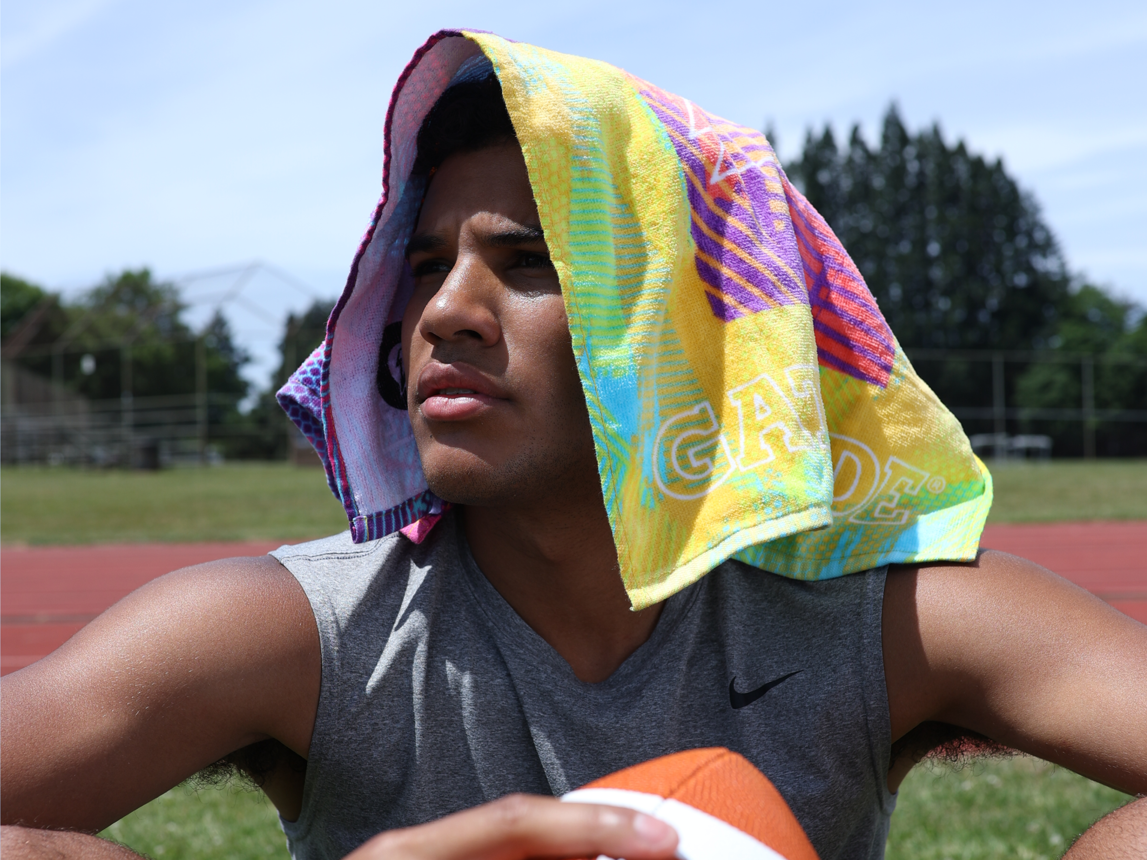 Athlete wearing a Gx Towel Tropic Guava towel on their head