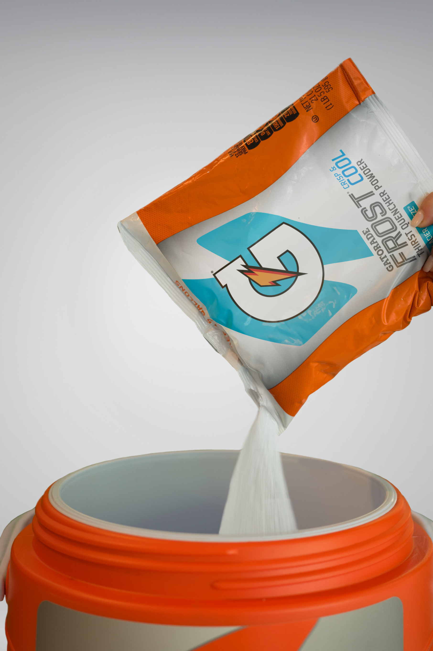 Gatorade thirst quencher glacier freeze 2.5 gallon bag glacier freeze being poured into cooler