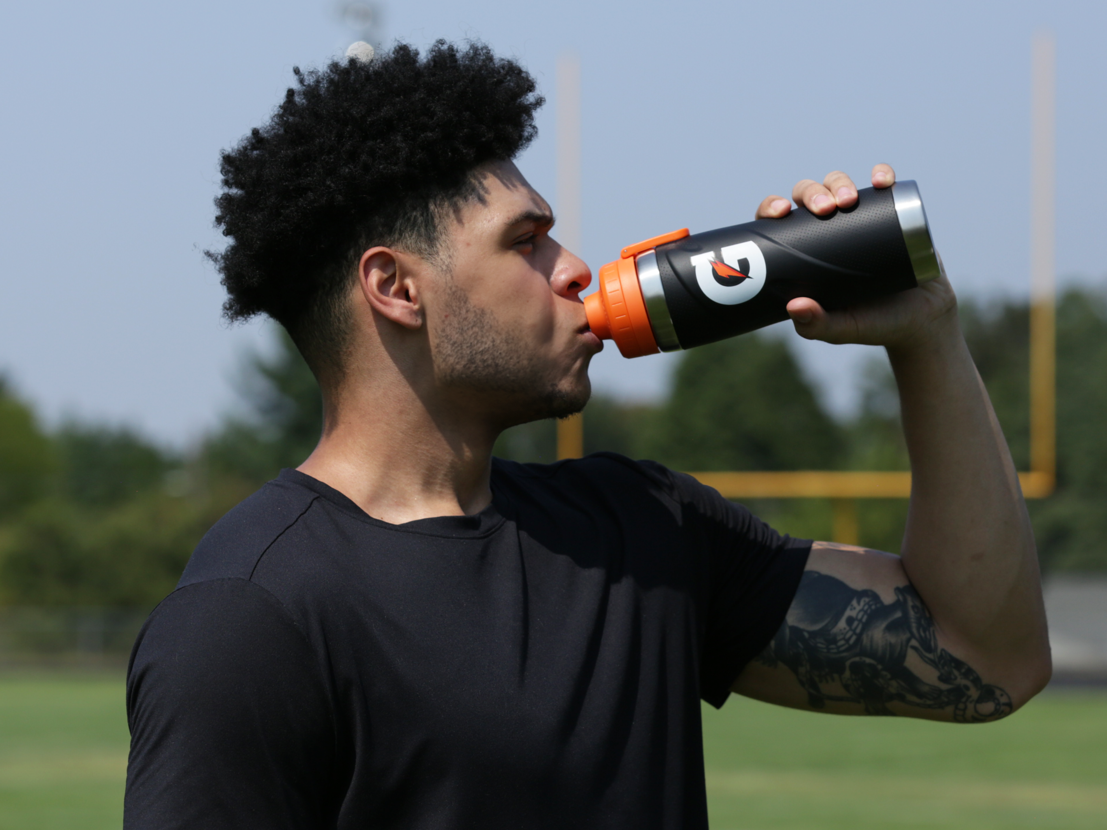 Athlete drinking out of Gx Stainless steel bottle