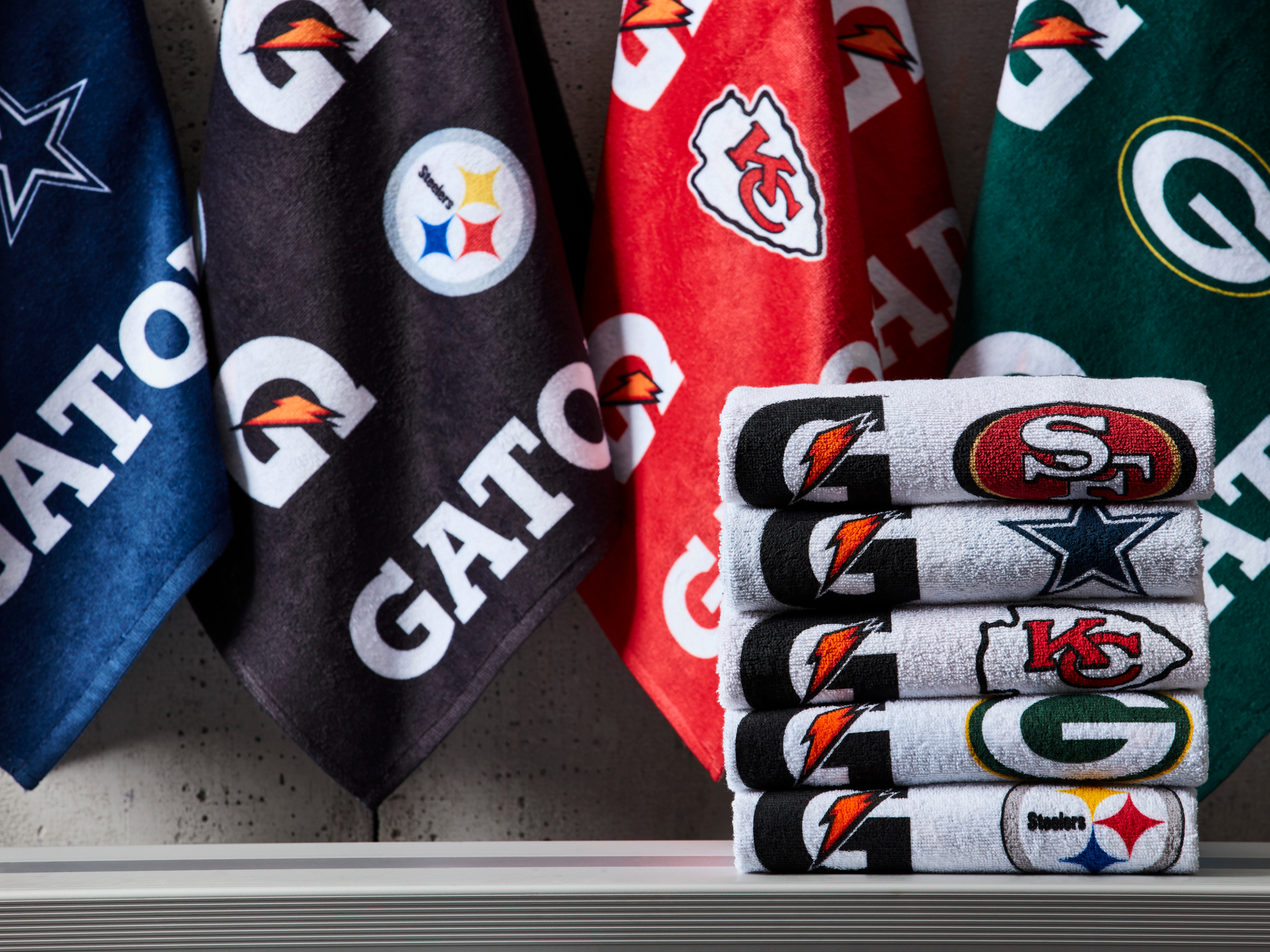 Stack of NFL Pro Towels on a bench.