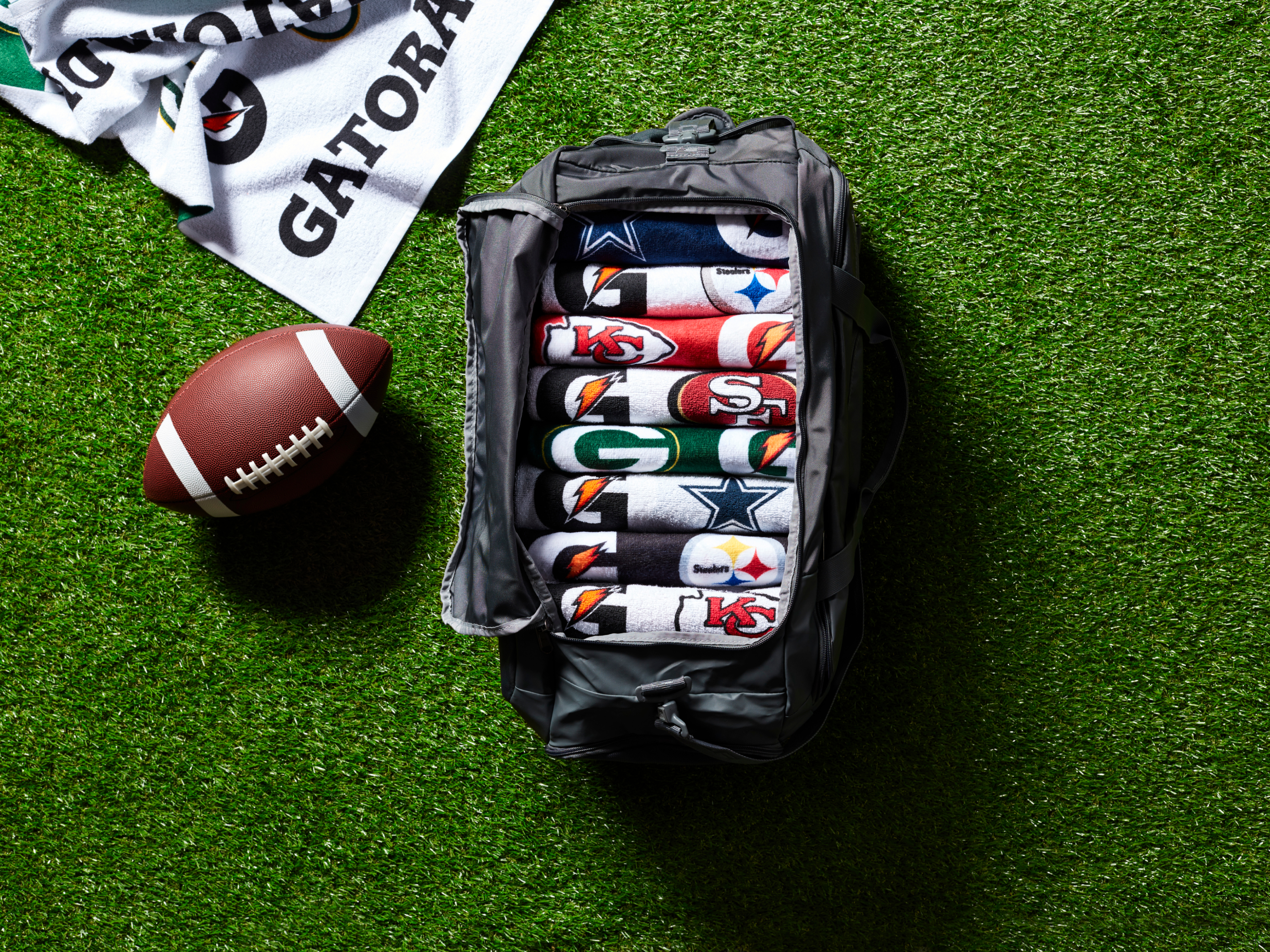 NFL Pro Towels in a gym bag on turf.