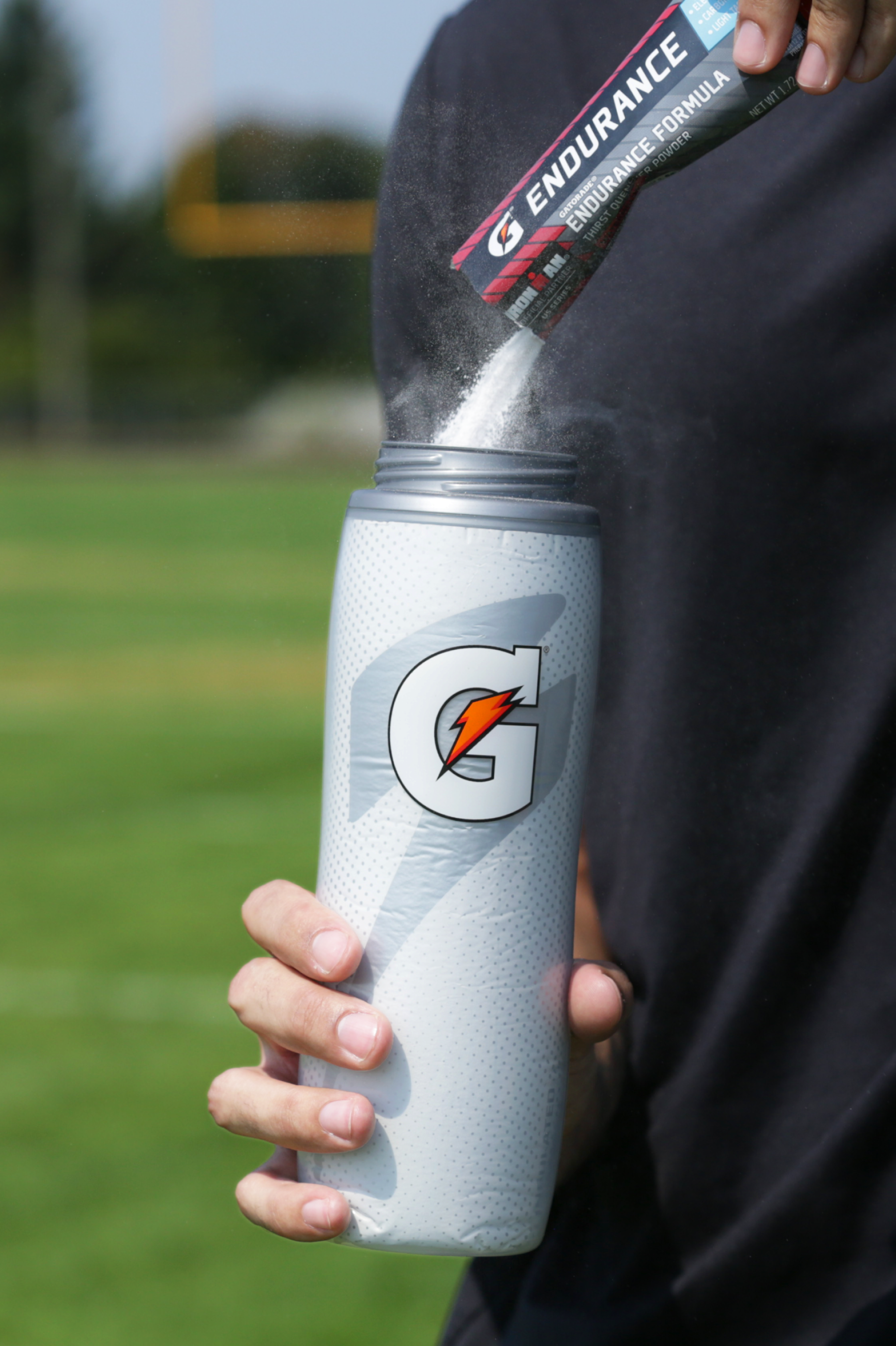 Powder being poured into White insulated bottle