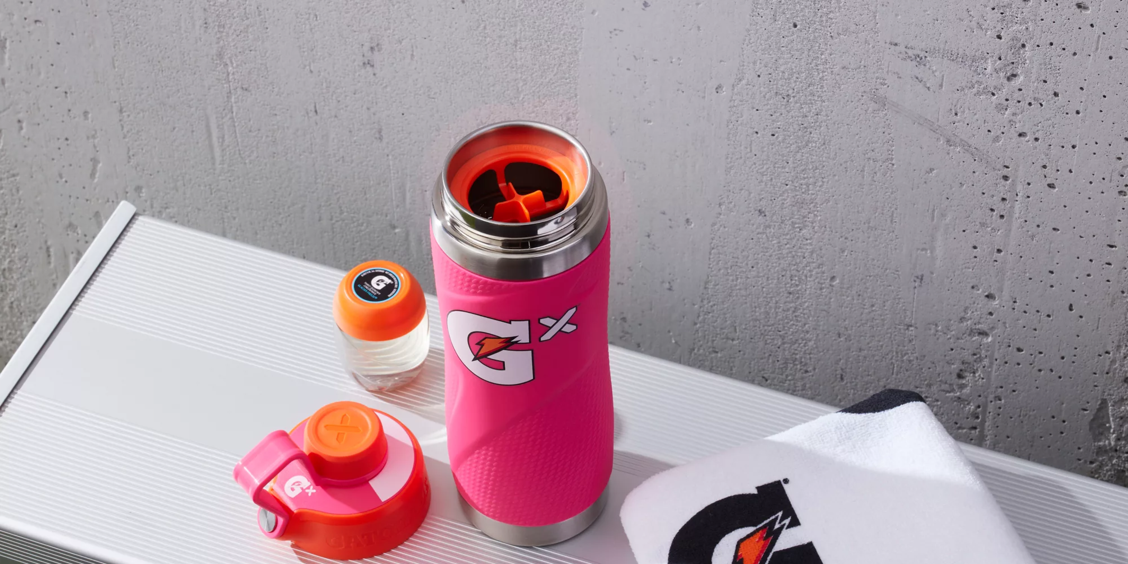 Gx Stainless Steel Bottle with the top off exposing where Gx Pod is pierced  with Gx Pod and bottle lid